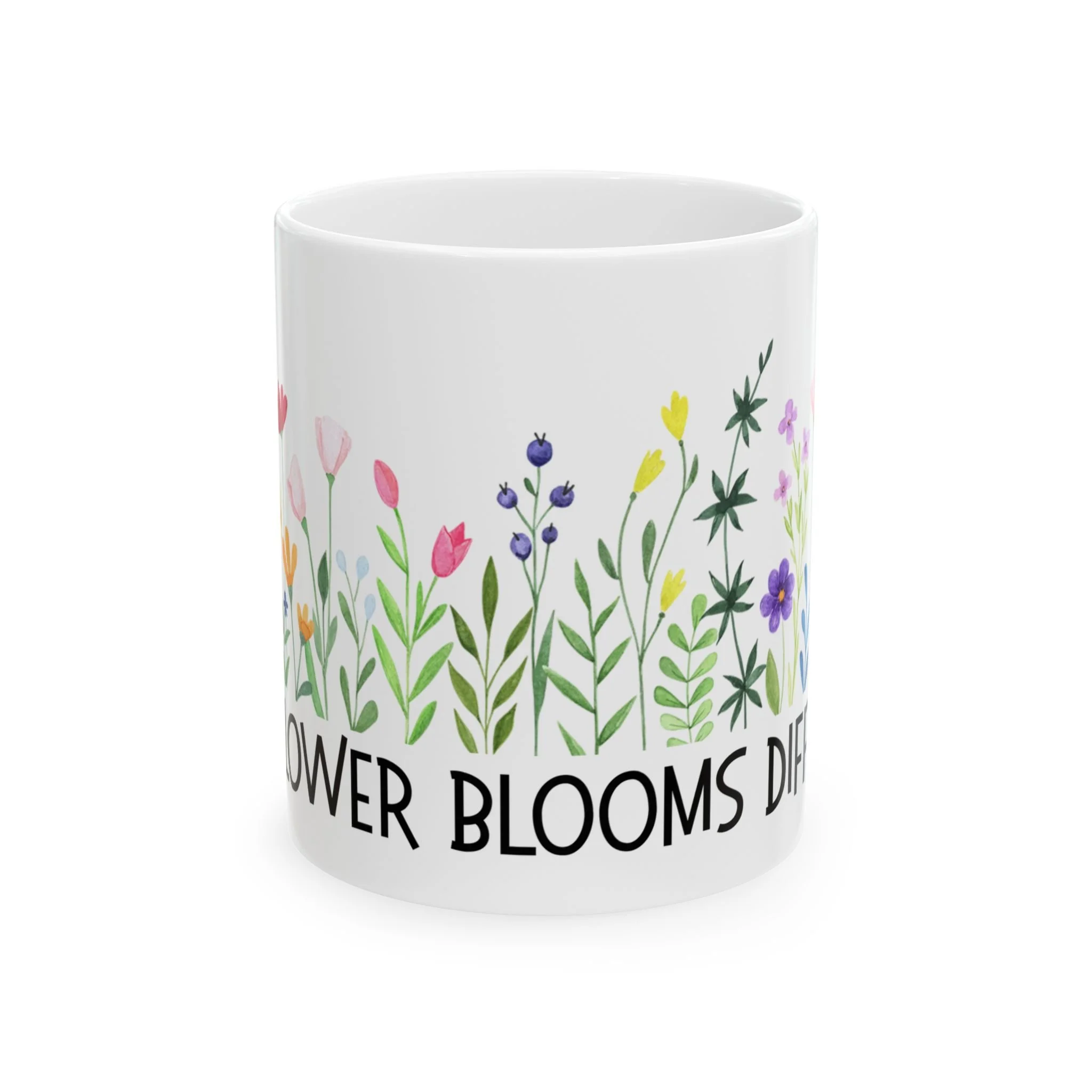 Side view of mug showing bright mixed wildflowers across the surface