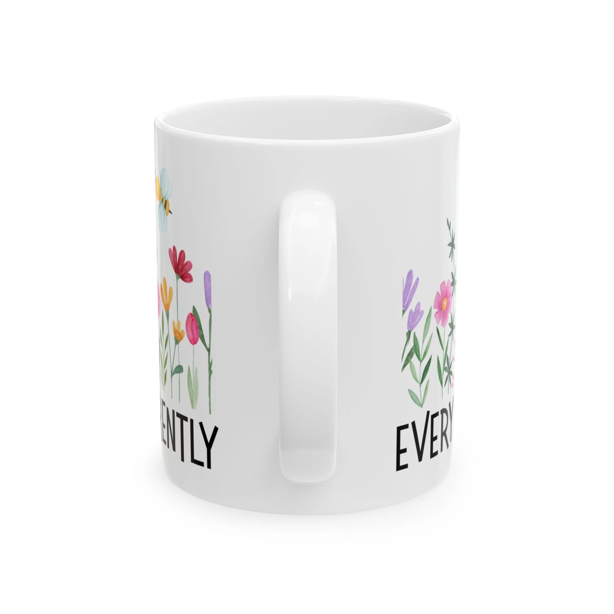 Side profile of mug showing white handle and partial floral artwork