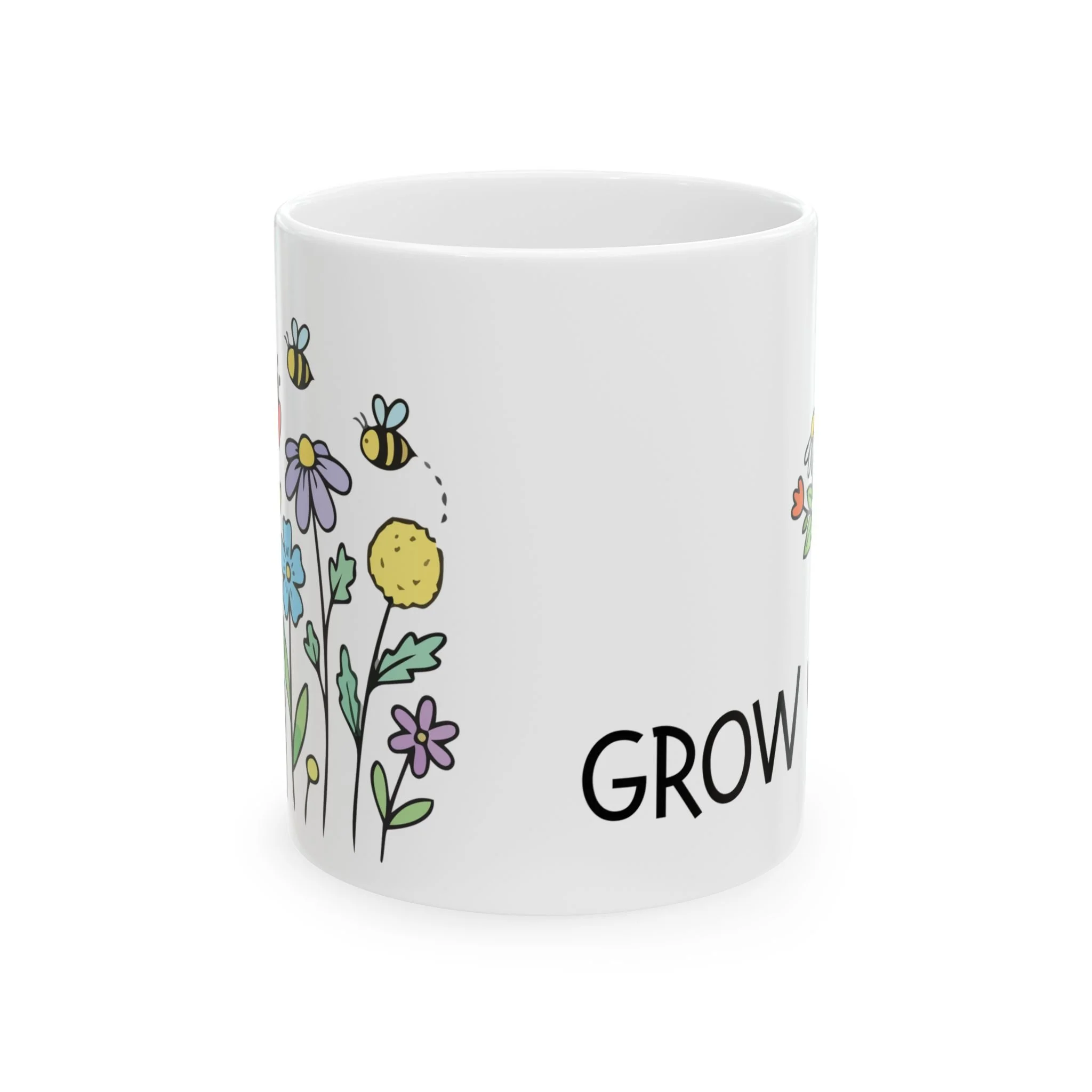 Side view of mug showing bright hand-drawn flowers and bees