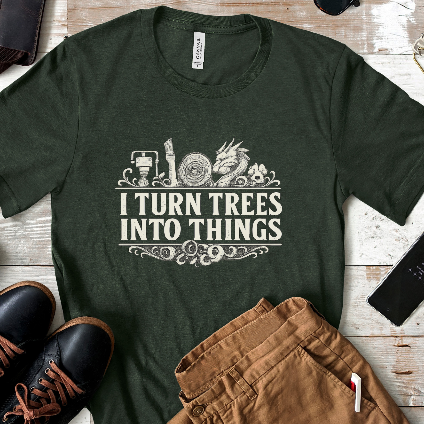 Green "I Turn Trees Into Things" laser engraving and maker t-shirt flat lay