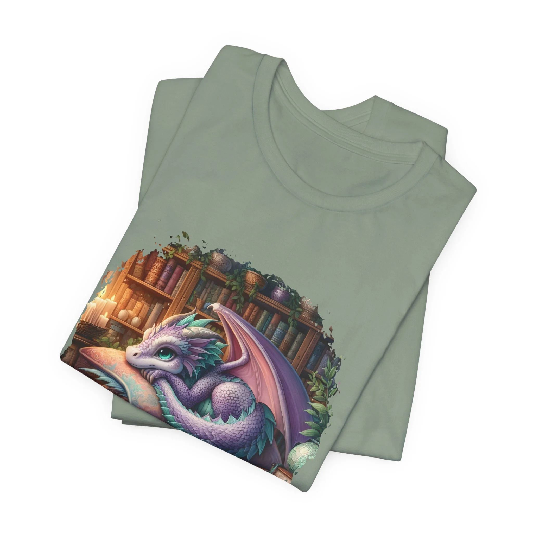 Sage green fantasy graphic tee with cute dragon illustration and bookshelf background.