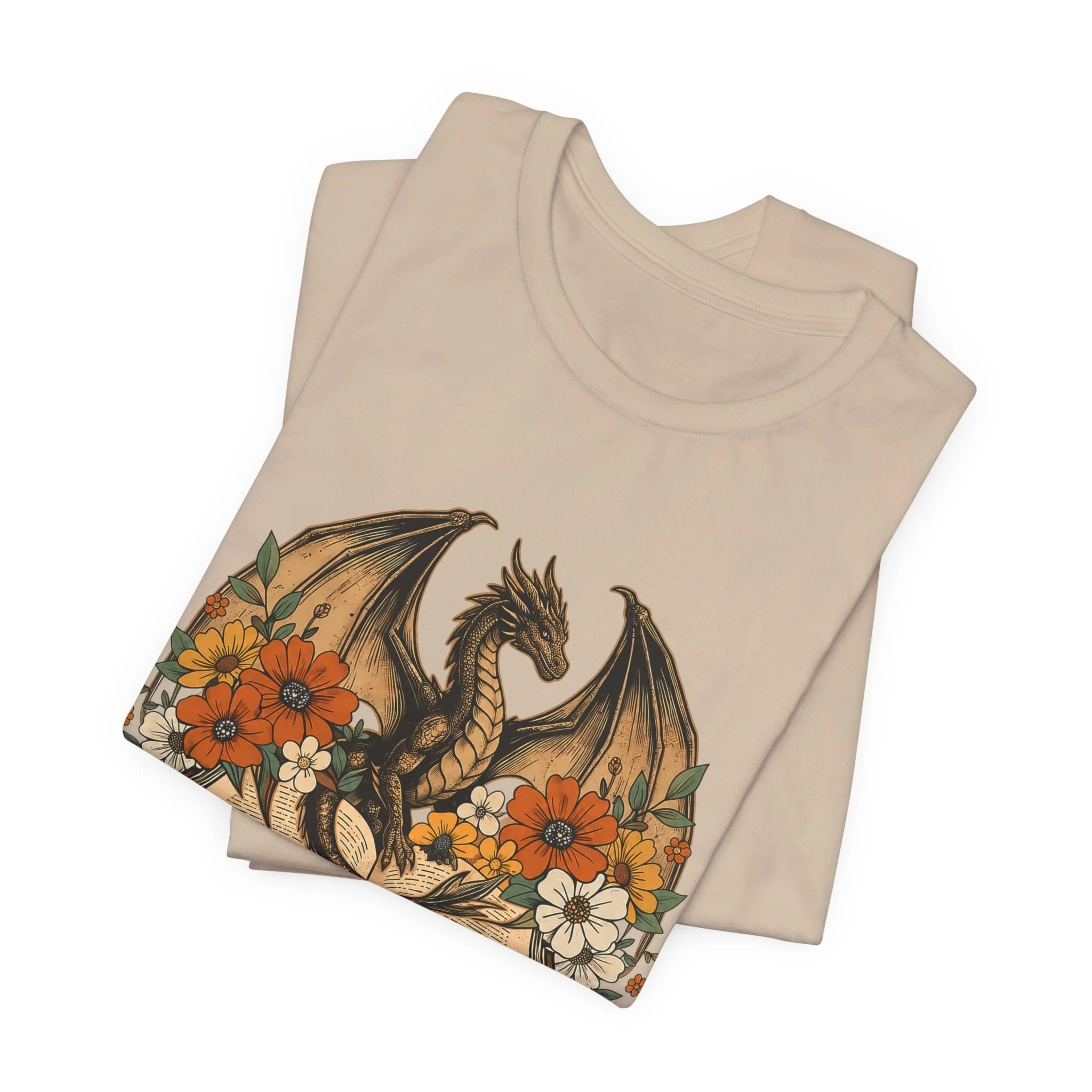 Tan colored fantasy graphic tee with dragon perched above an open book and autumn blooms.