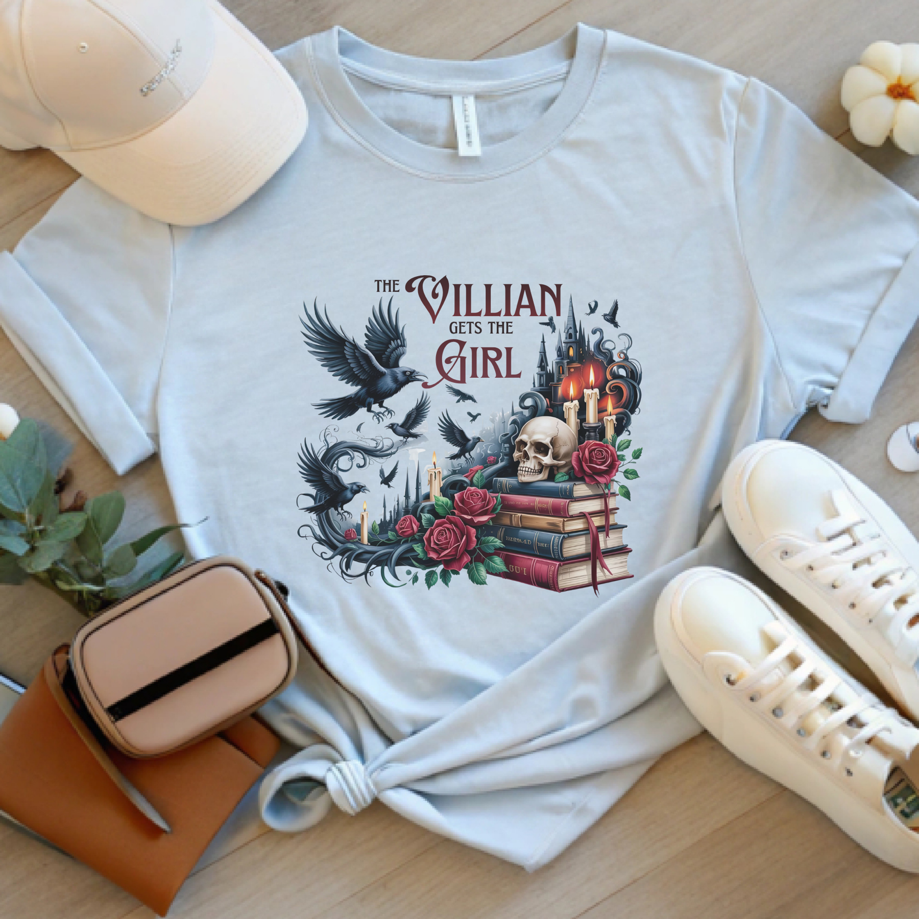 Silver fantasy reader t-shirt featuring "The Villain Girl" design with ravens, books, roses, and candles.
