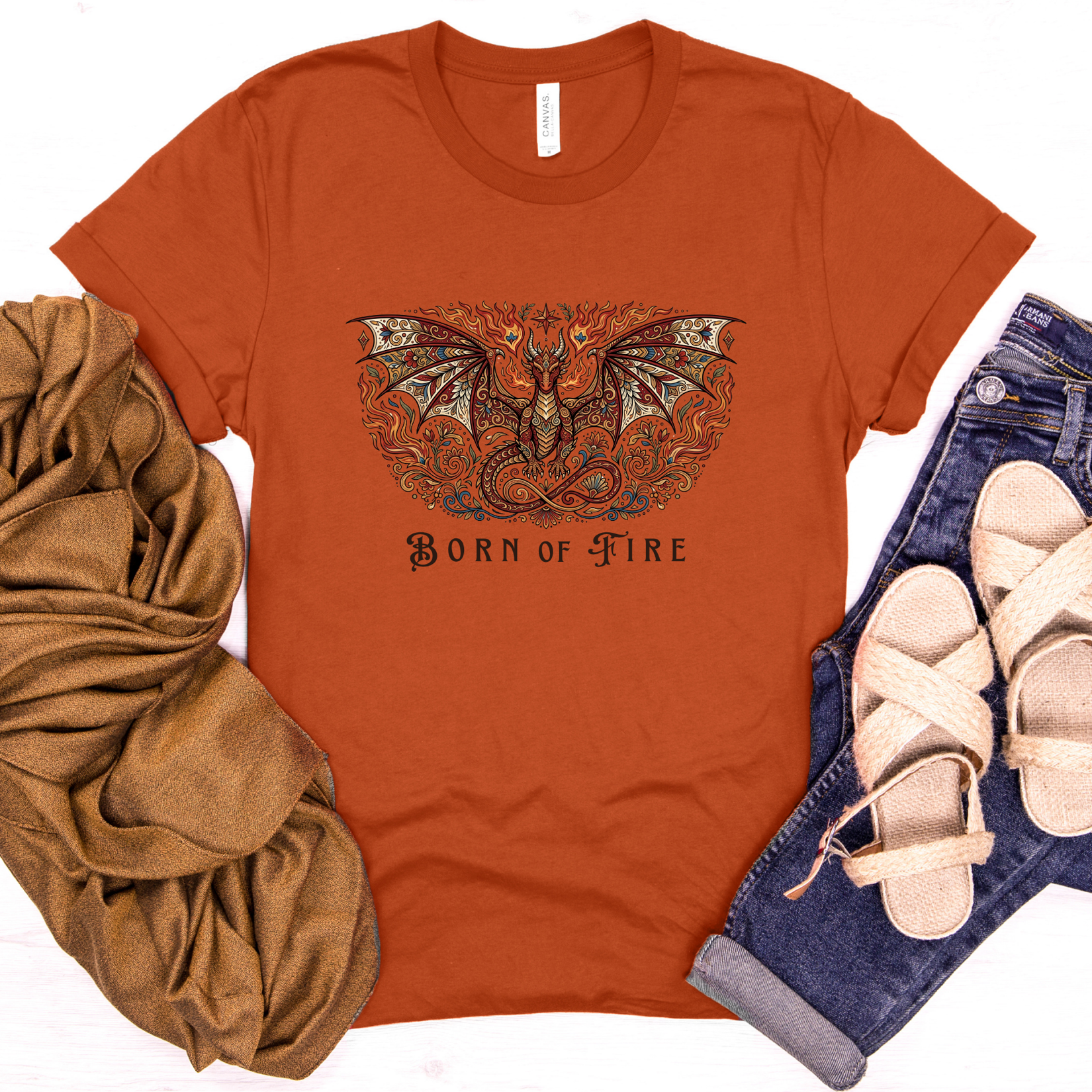 Autumn-colored fantasy t-shirt featuring an ornate dragon design and the phrase "Born of Fire."