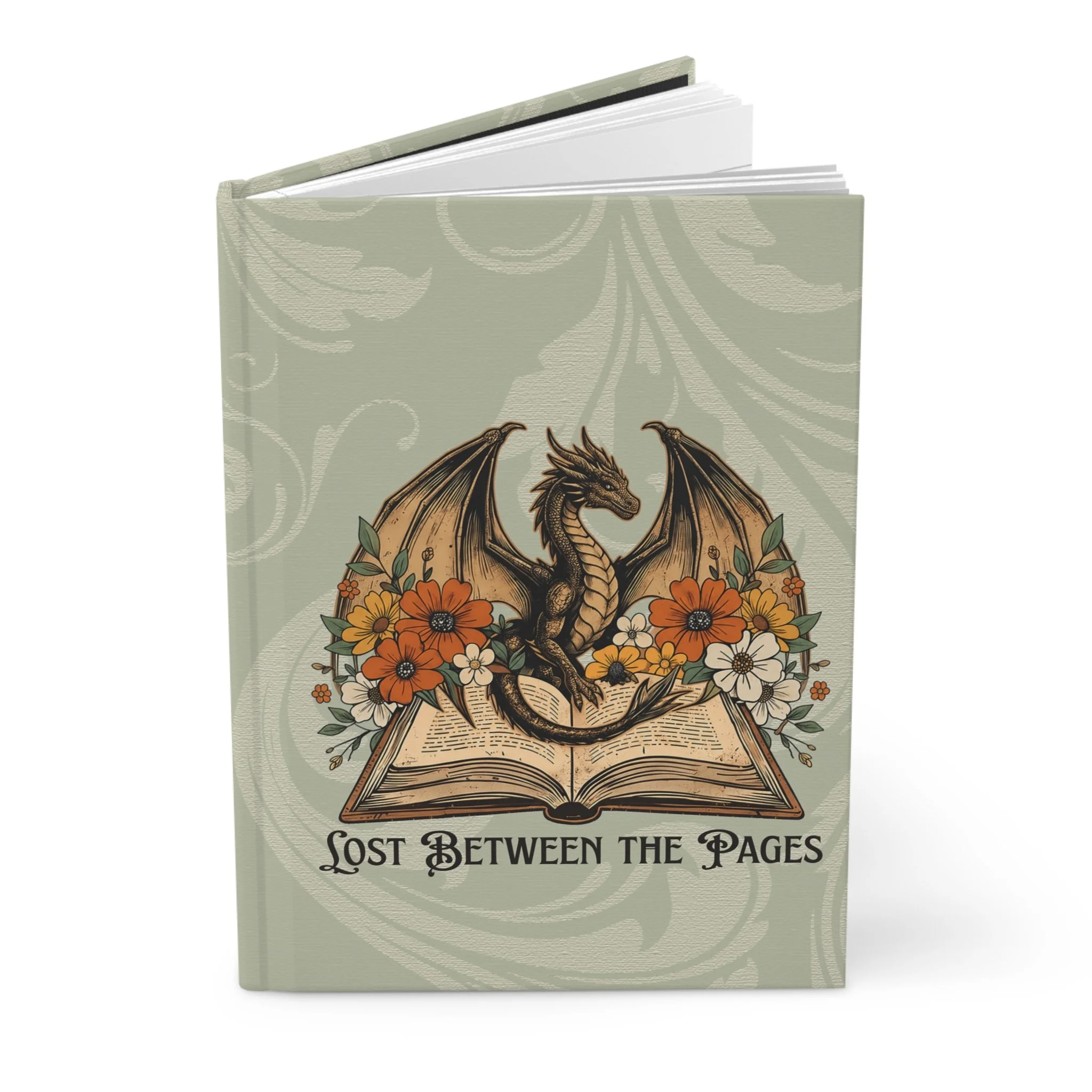 Standing hardcover journal with dragon and floral artwork on a sage green cover.