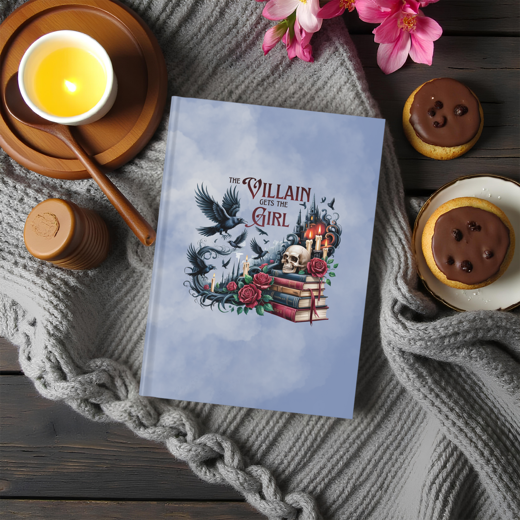 Hardcover fantasy journal featuring books, a raven, roses, and the phrase "The Villain Gets the Girl."