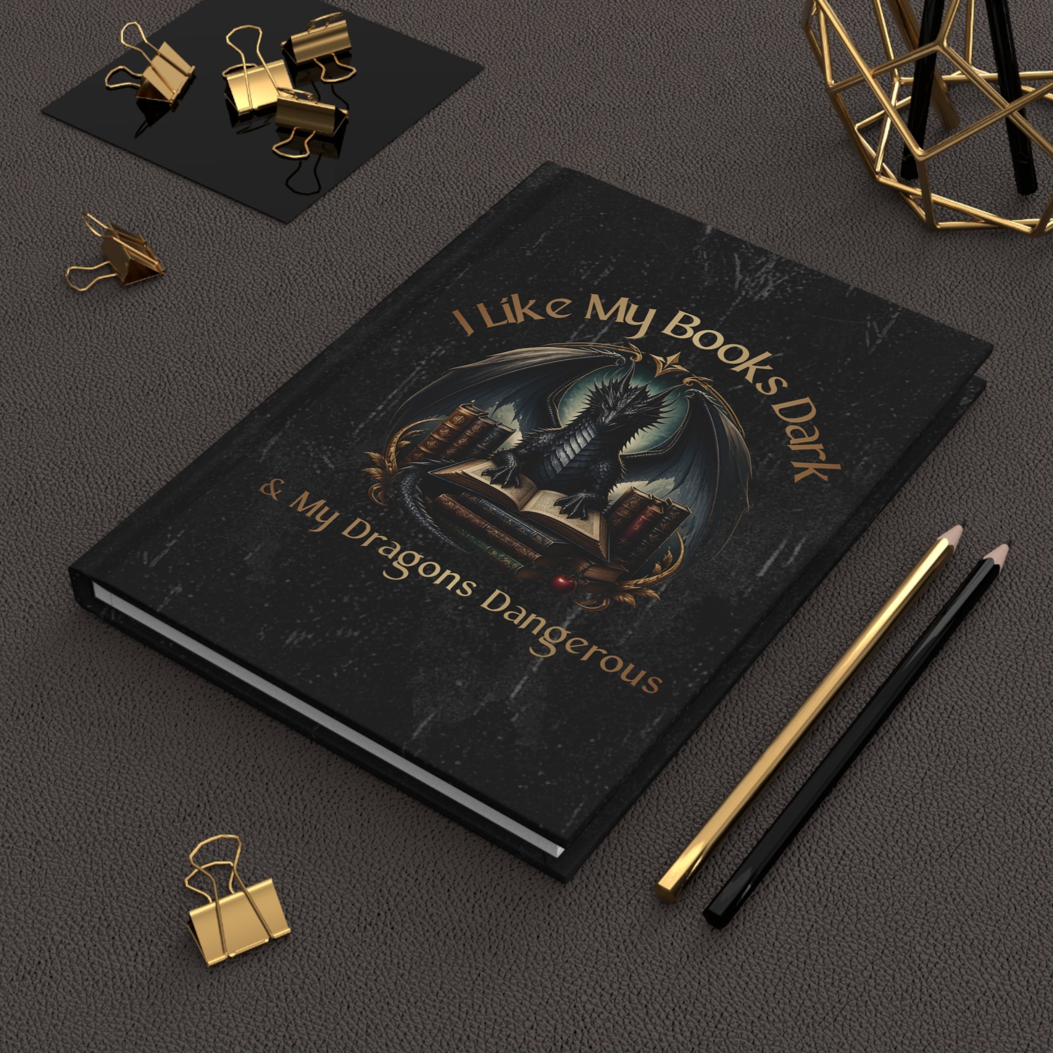Dark fantasy hardcover notebook displayed on a desk with stationery and library shelves in the background.