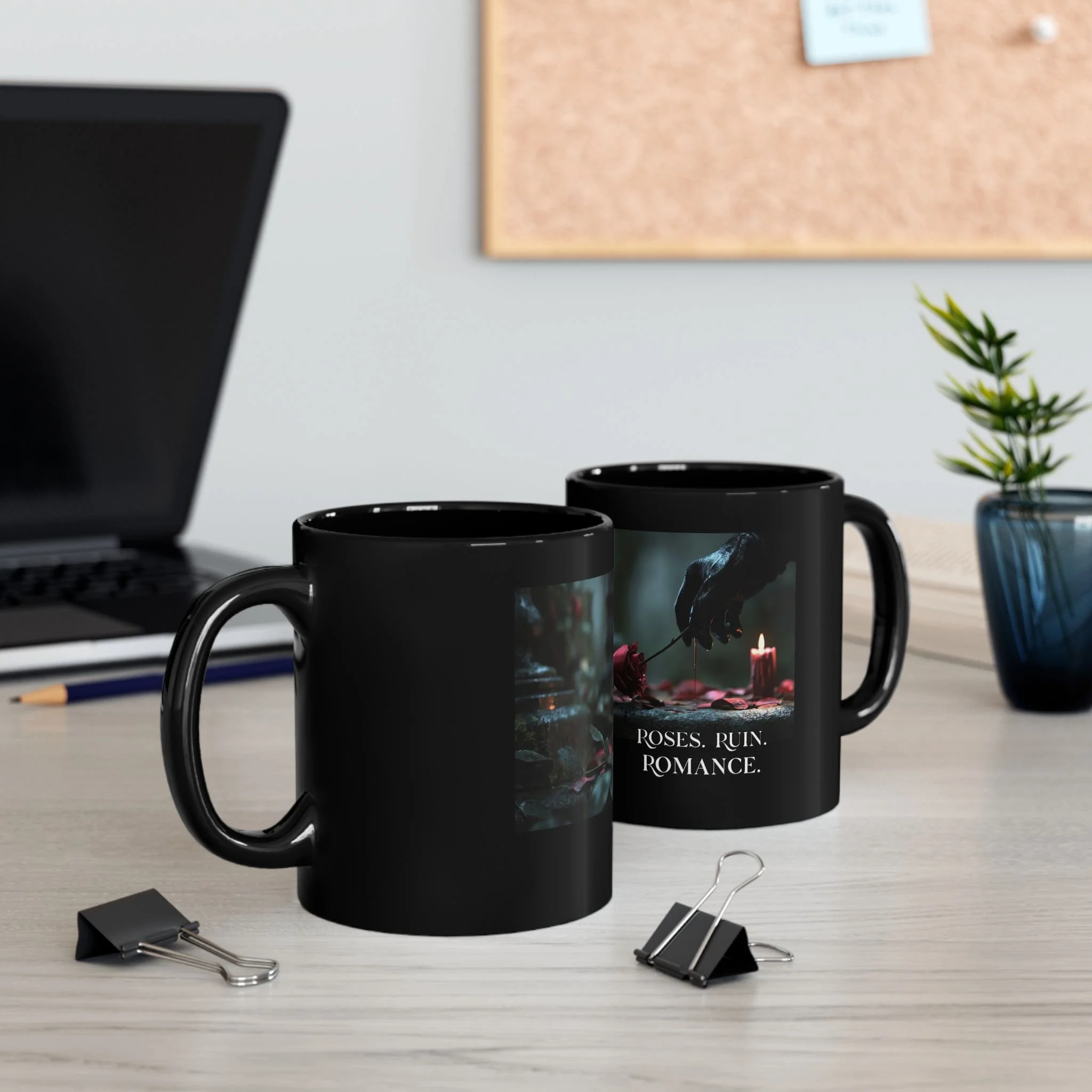 Roses Ruin Romance black ceramic mug displayed on a desk