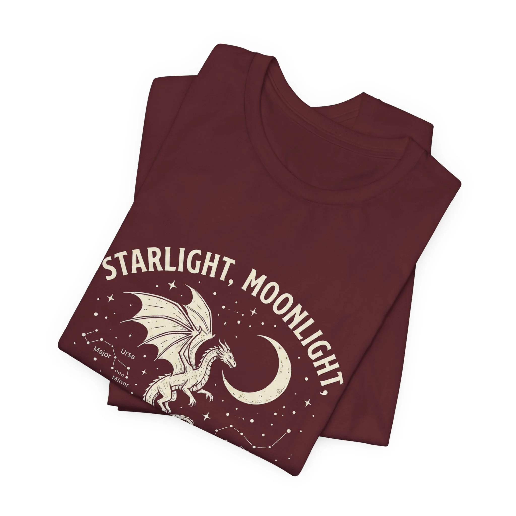 Folded Maroon Bella+Canvas t-shirt featuring the "Starlight, Moonlight, and Dragon Flight" design.