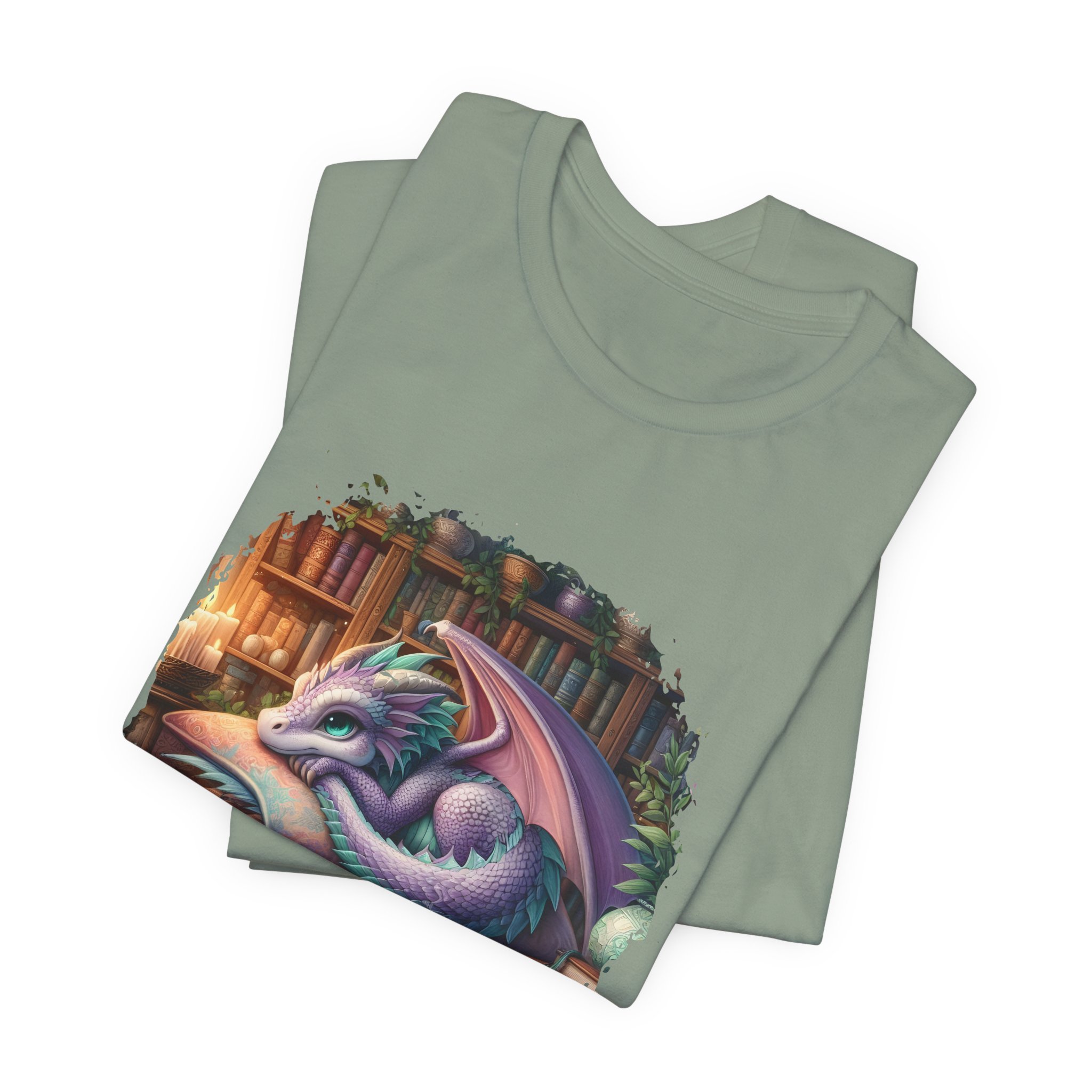 Sage green fantasy graphic tee with cute dragon illustration and bookshelf background.