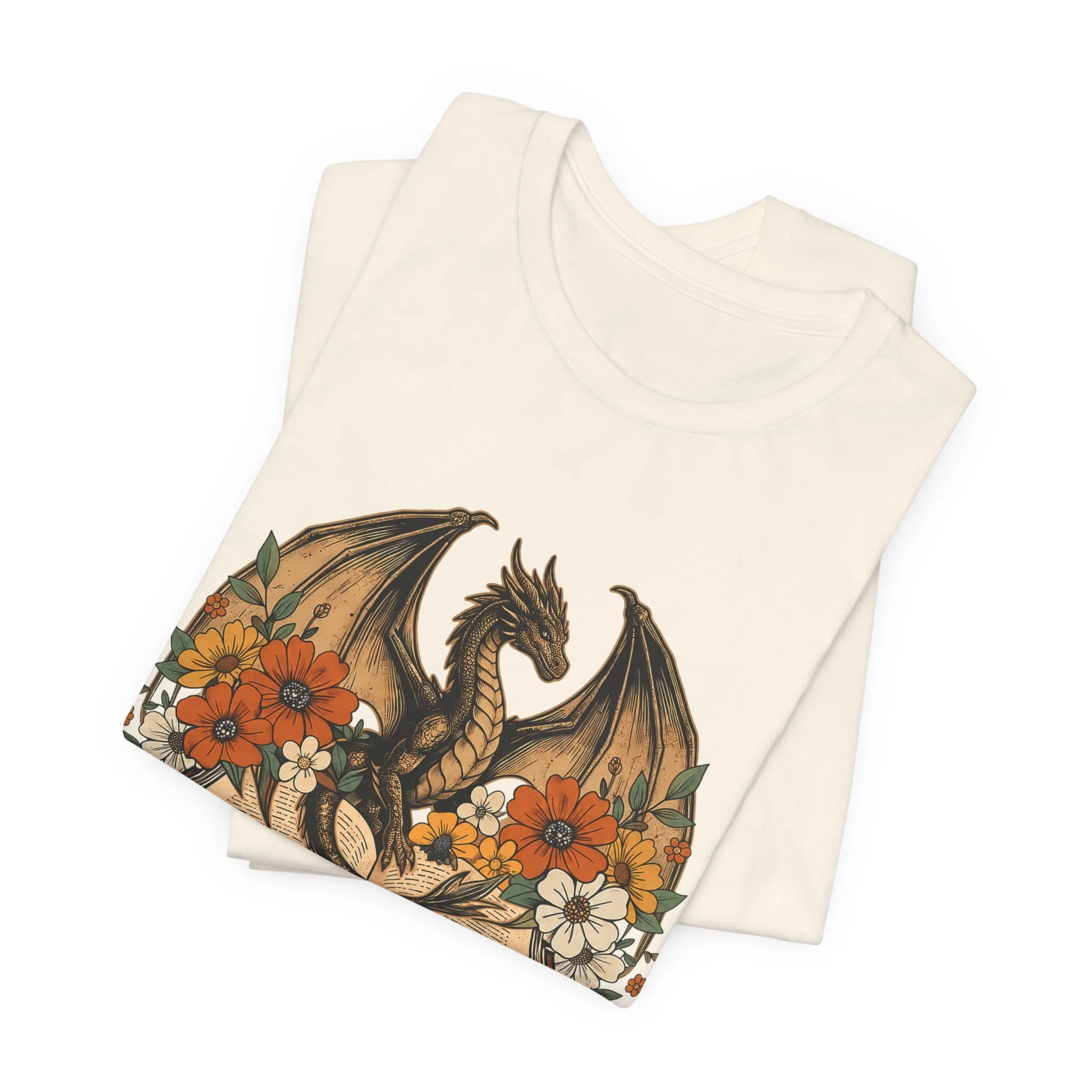 Cream-colored dragon reader shirt featuring an open book surrounded by florals and fantasy artwork.