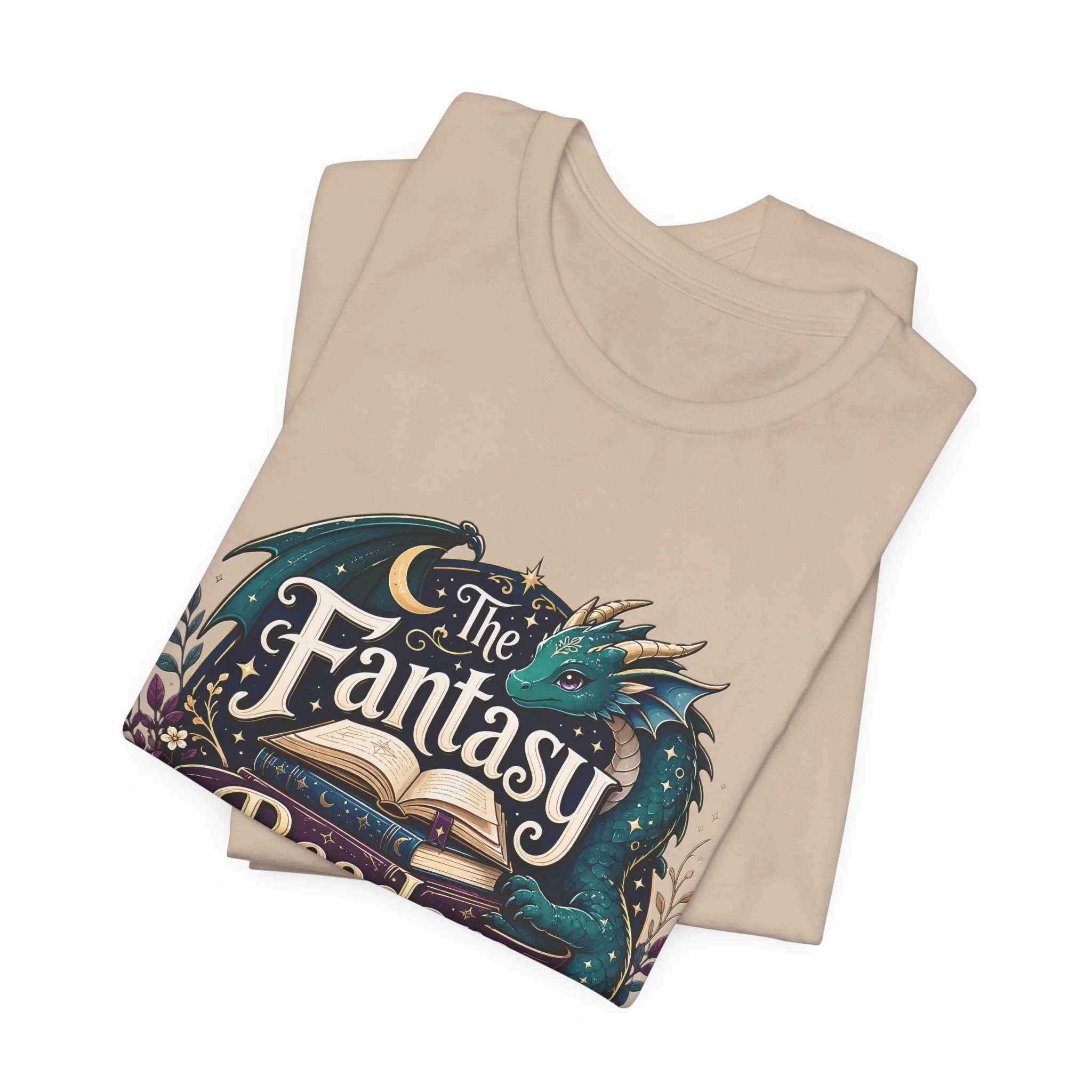 Sand-colored fantasy book lover t-shirt with whimsical dragon illustration and stacked books.