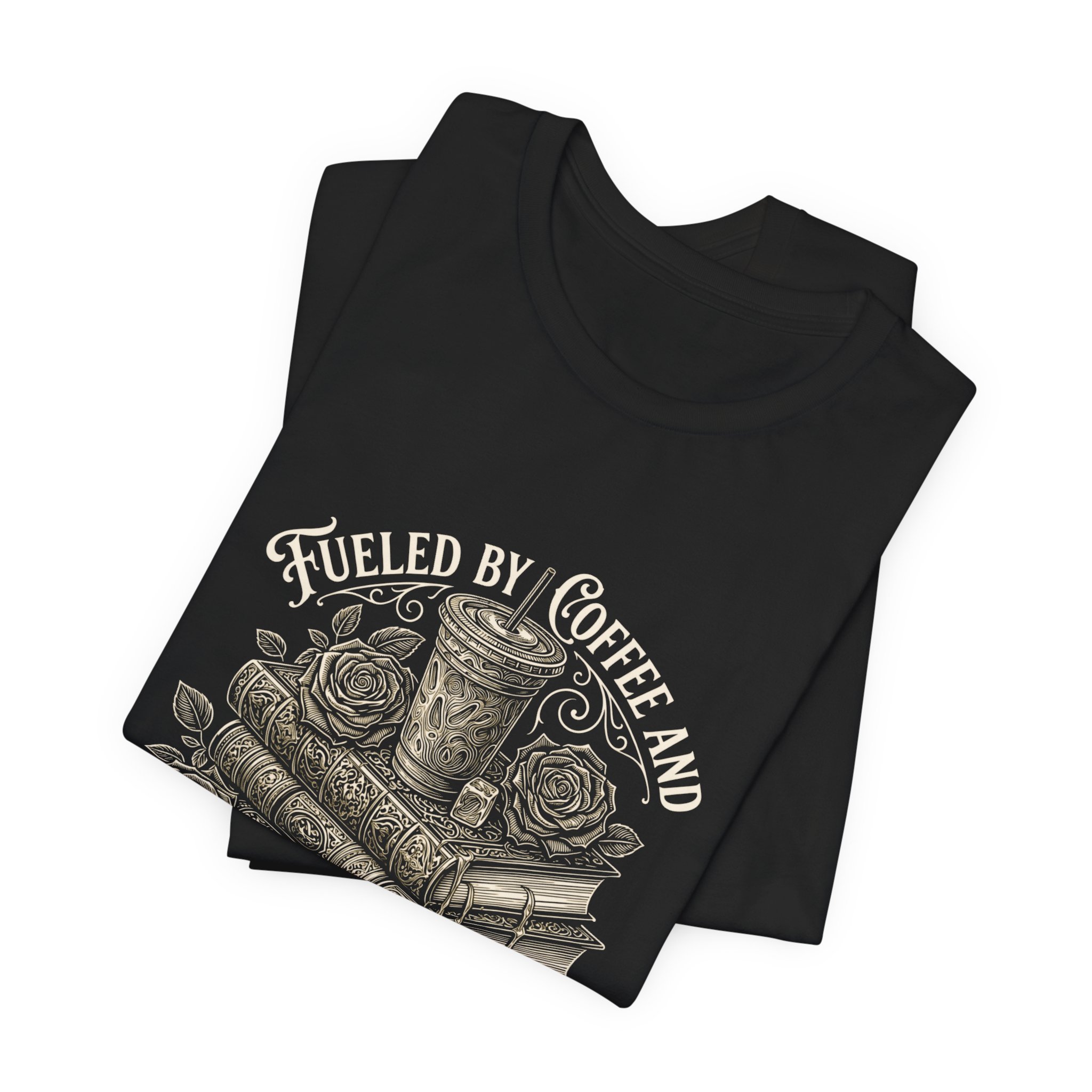 Folded Black Bella+Canvas fantasy reader graphic t-shirt with vintage books and coffee artwork.