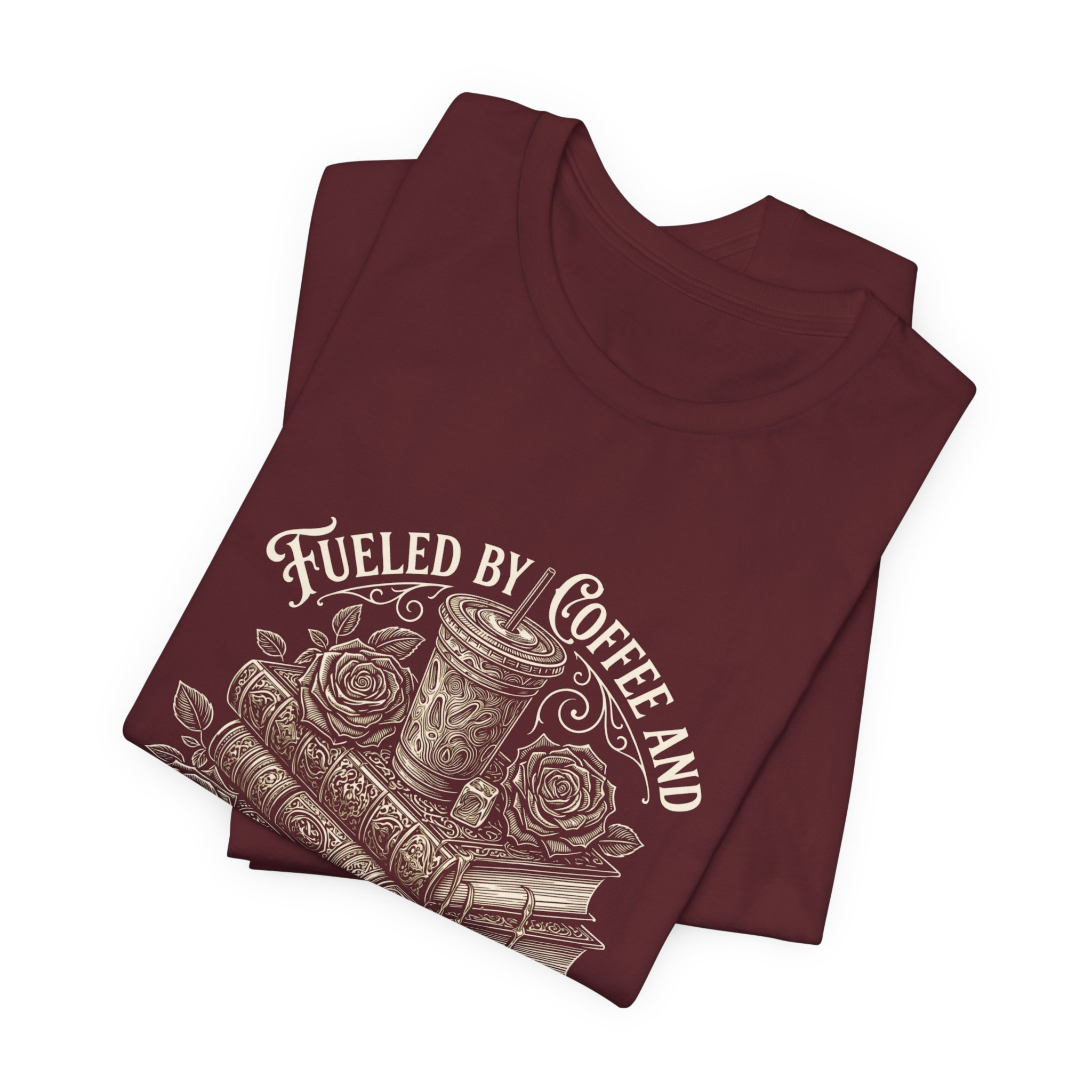 Folded Maroon Bella+Canvas fantasy reader graphic t-shirt featuring the "Fueled by Coffee and Smutty Tales" design.