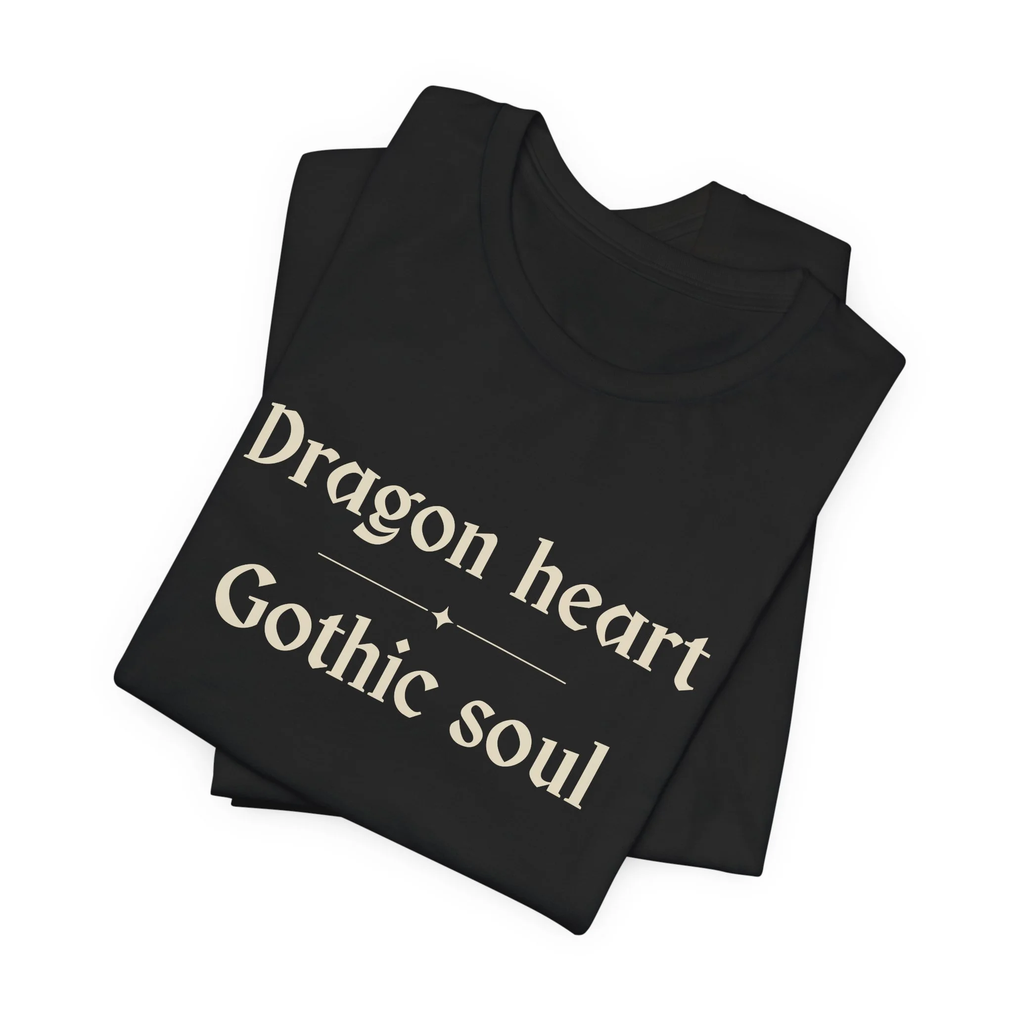 Folded Black Bella+Canvas fantasy typography t-shirt with the phrase "Dragon Heart, Gothic Soul."