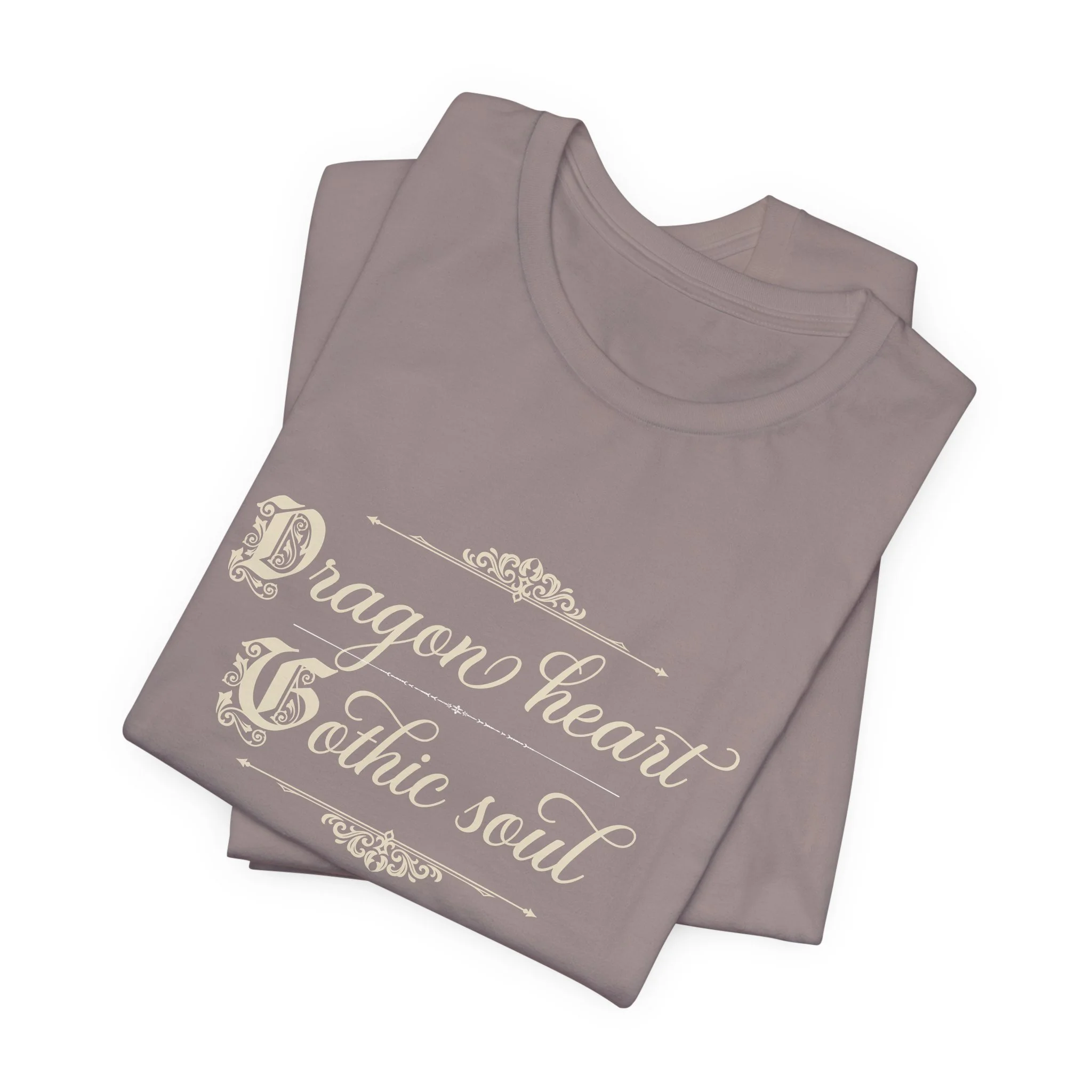 Folded Pebble Brown Bella+Canvas t-shirt featuring the vintage "Dragon Heart, Gothic Soul" graphic with decorative flourishes.