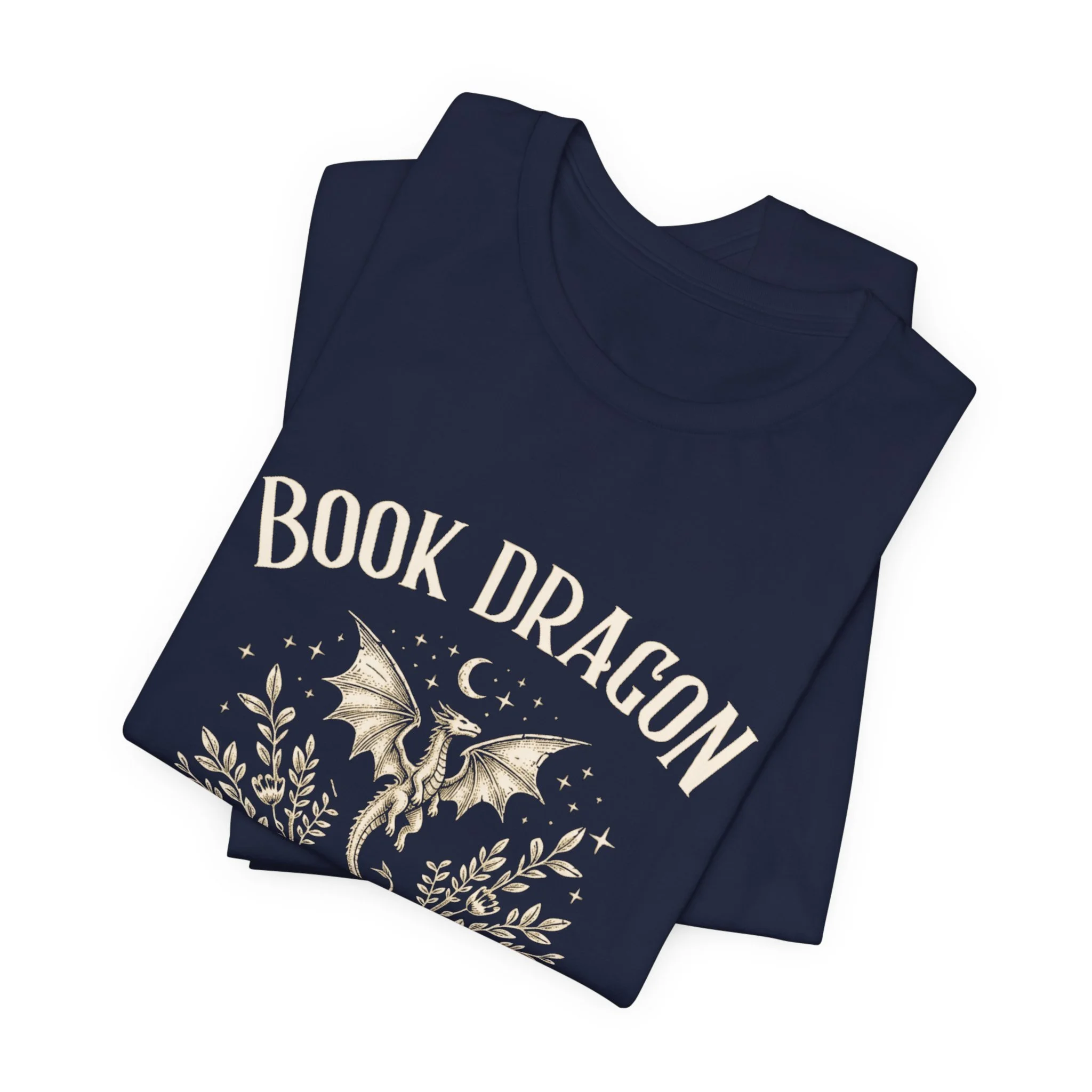 Folded Navy Bella+Canvas t-shirt featuring the "Book Dragon" design.