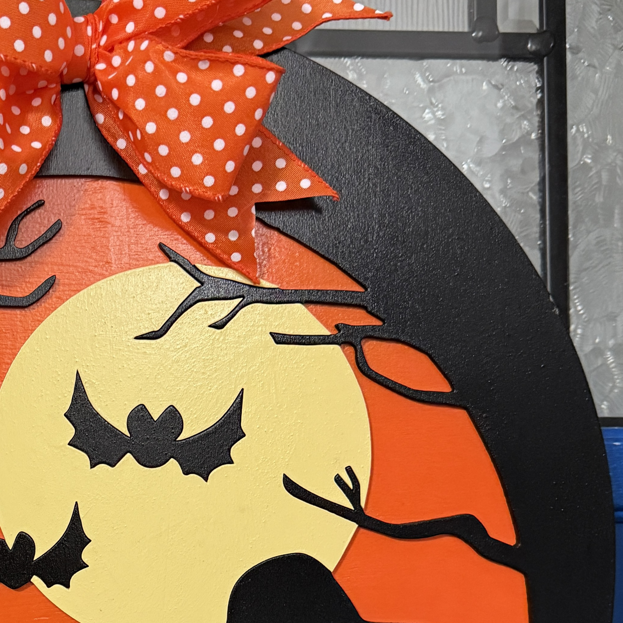 Close-up of Trick-or-Treat door hanger highlighting moon, bats, and Peanuts silhouettes