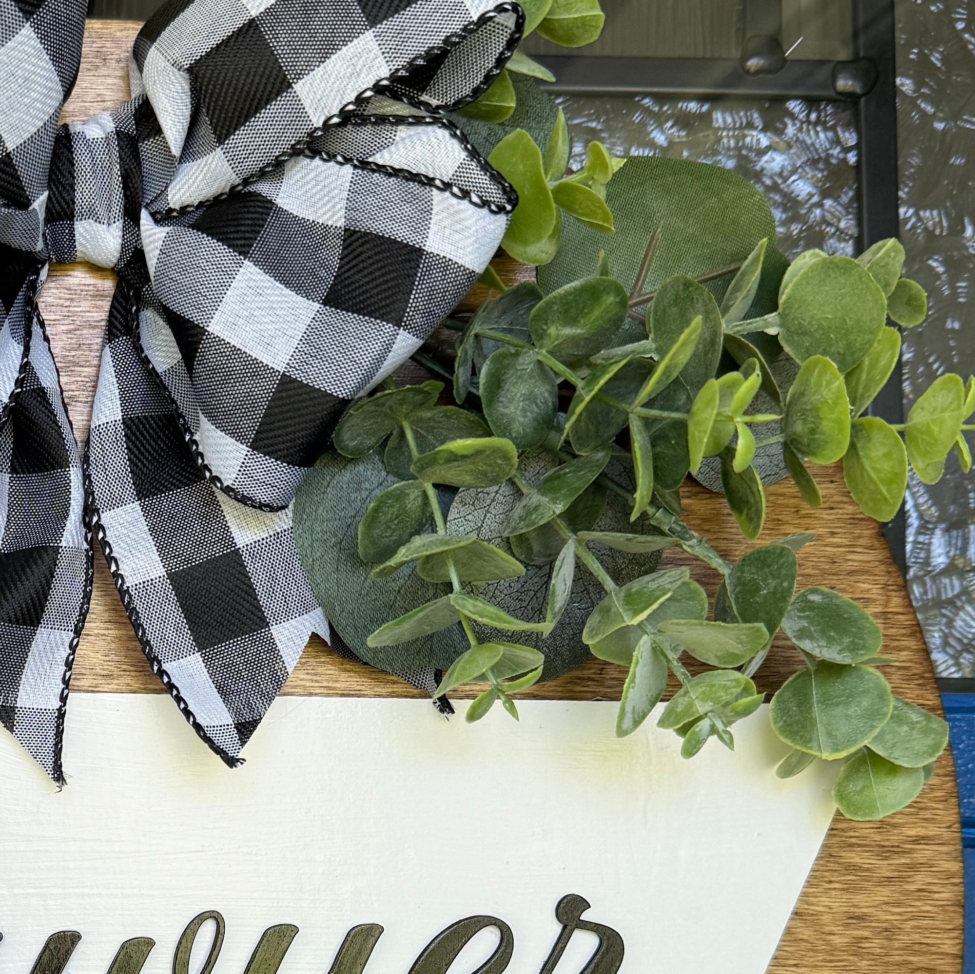 Custom established sign featuring family name and decorative greenery.