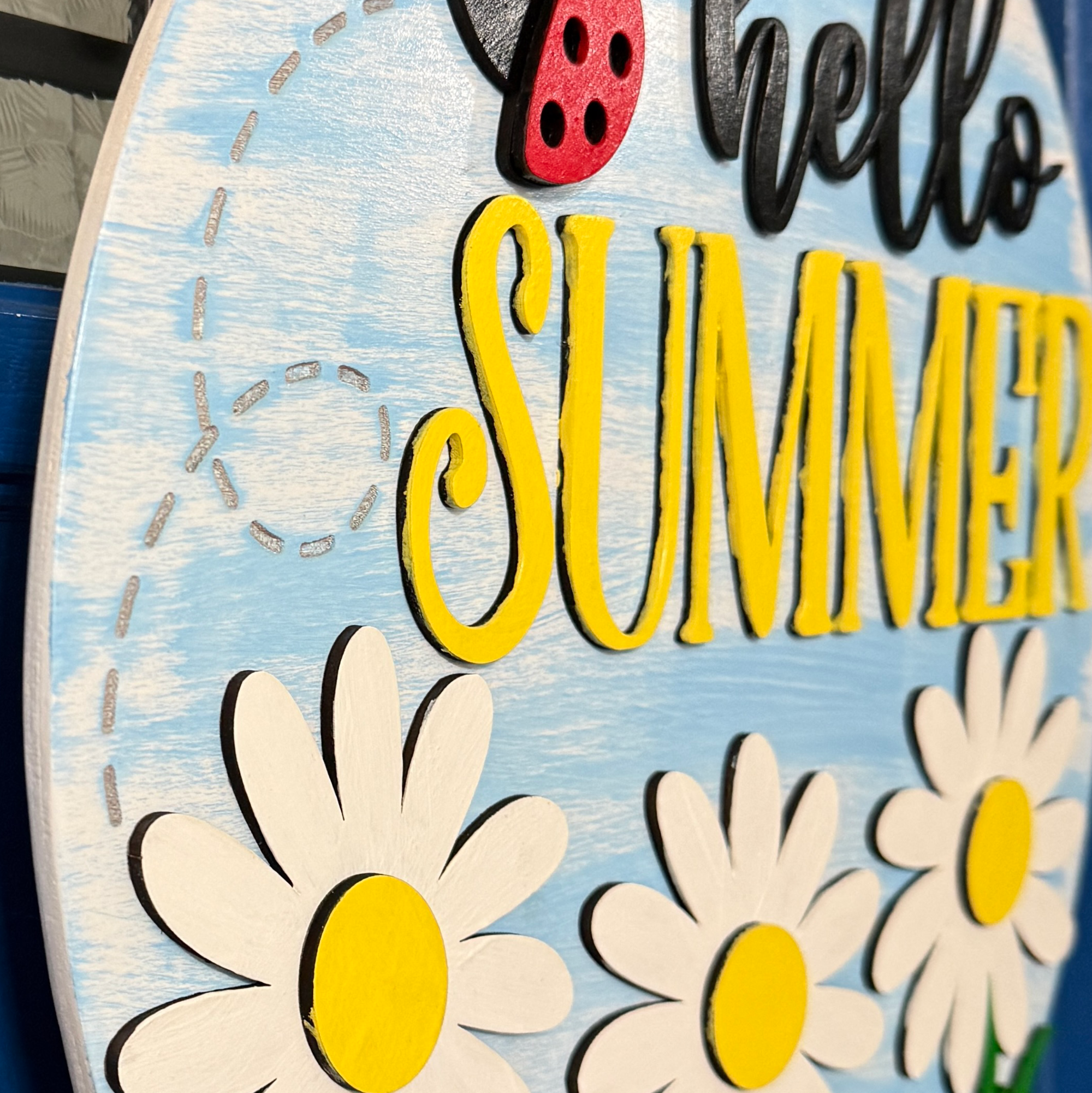 Side perspective showing dimensional lettering and floral layers on hello summer door hanger