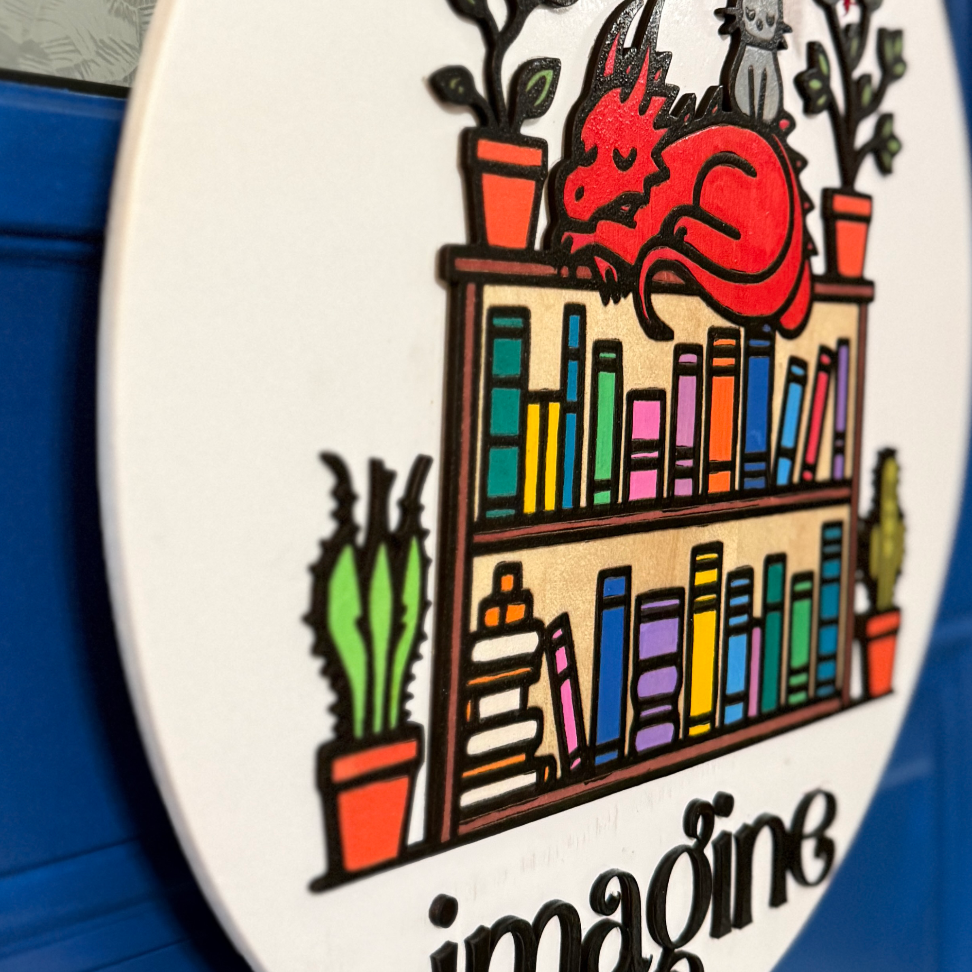 Side angle view highlighting layered bookshelf, plants, and dragon design elements