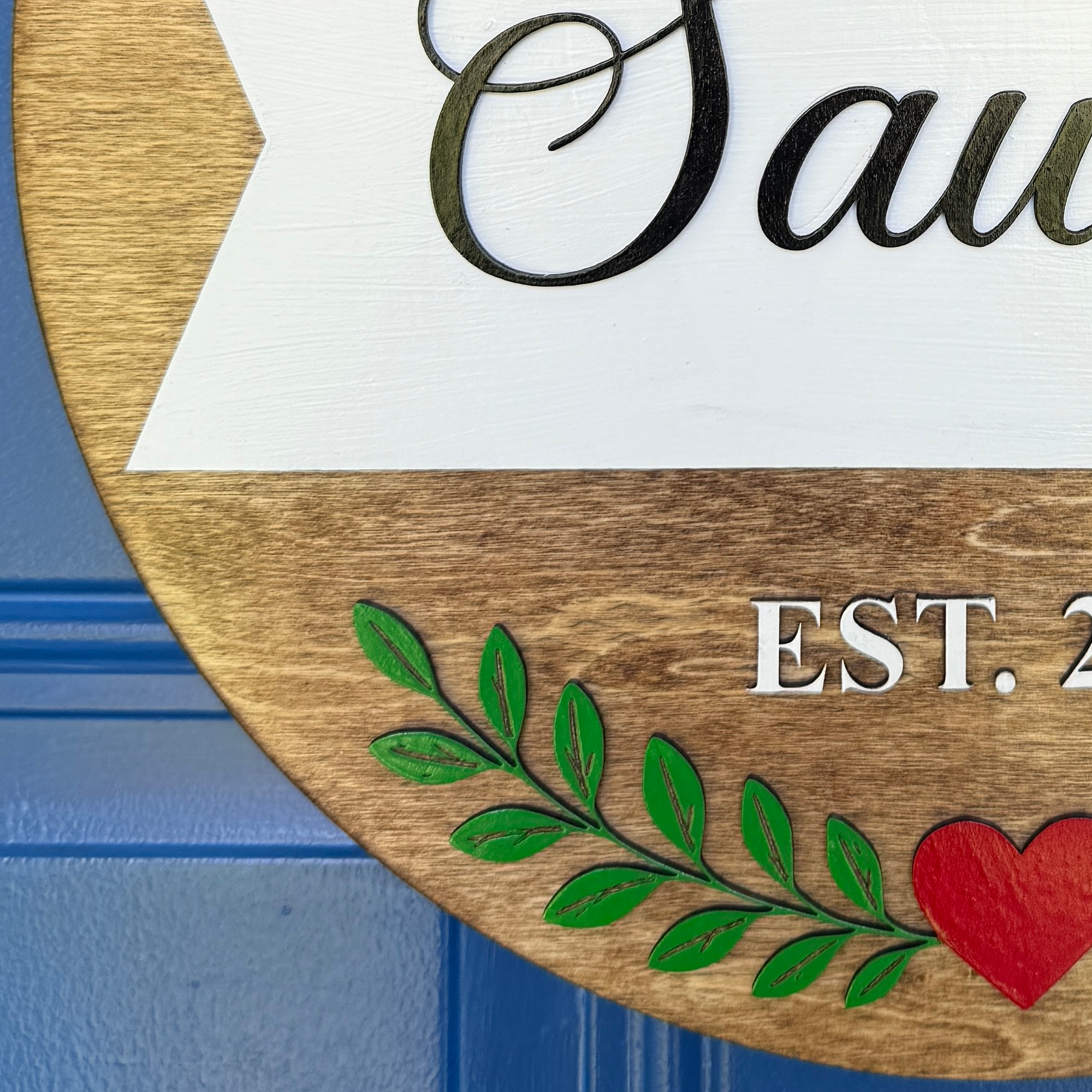 Personalized front door décor featuring custom last name and EST year.