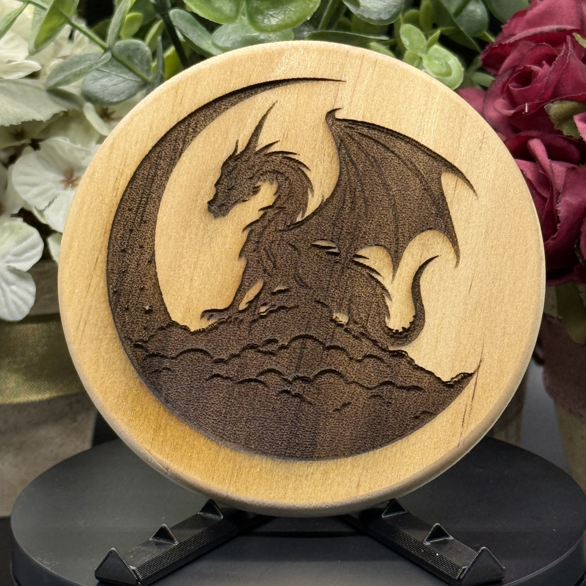 Round pine wood coaster featuring a dragon perched on a cloud inside a crescent moon silhouette, laser-engraved with bold detail