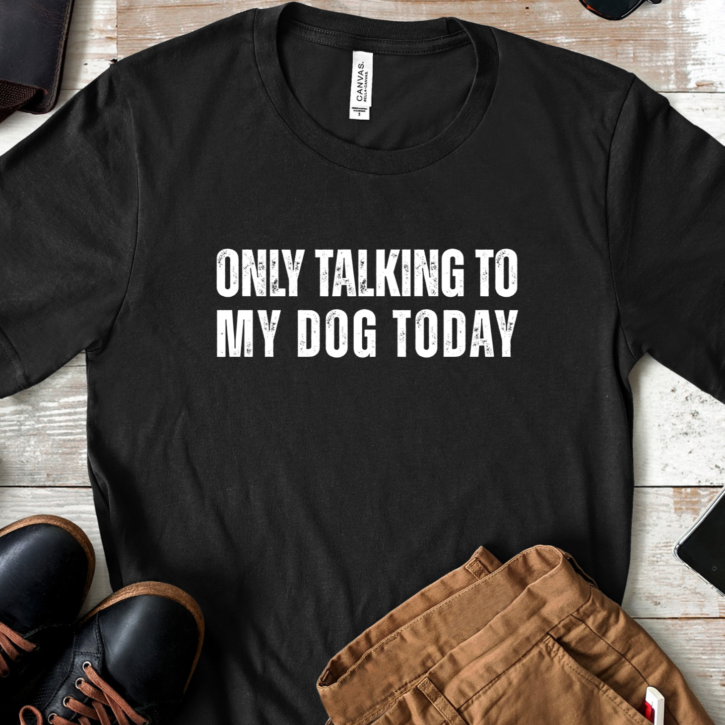 Flat lay of black dog lover t-shirt with “Only Talking to My Dog Today” text styled with shoes and accessories