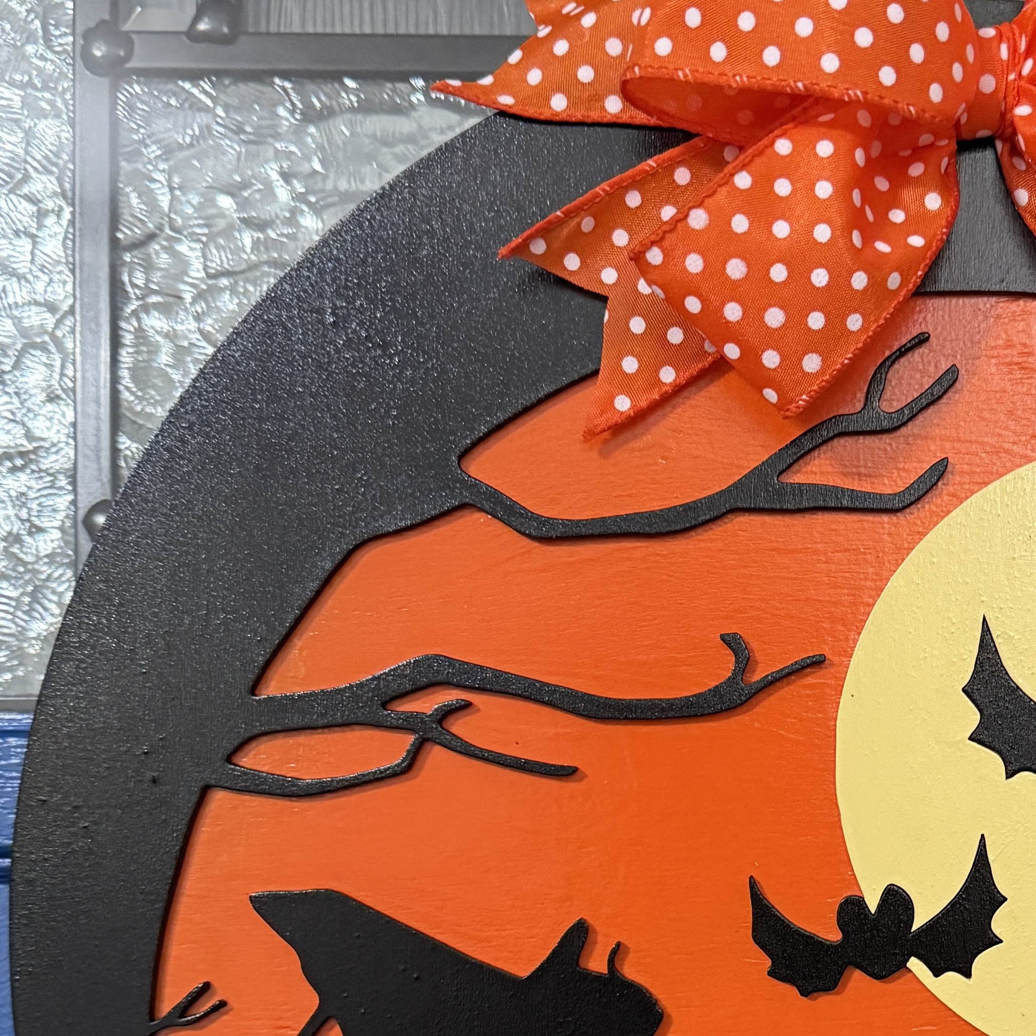 Close-up of Trick-or-Treat door hanger highlighting moon, bats, and Peanuts silhouettes