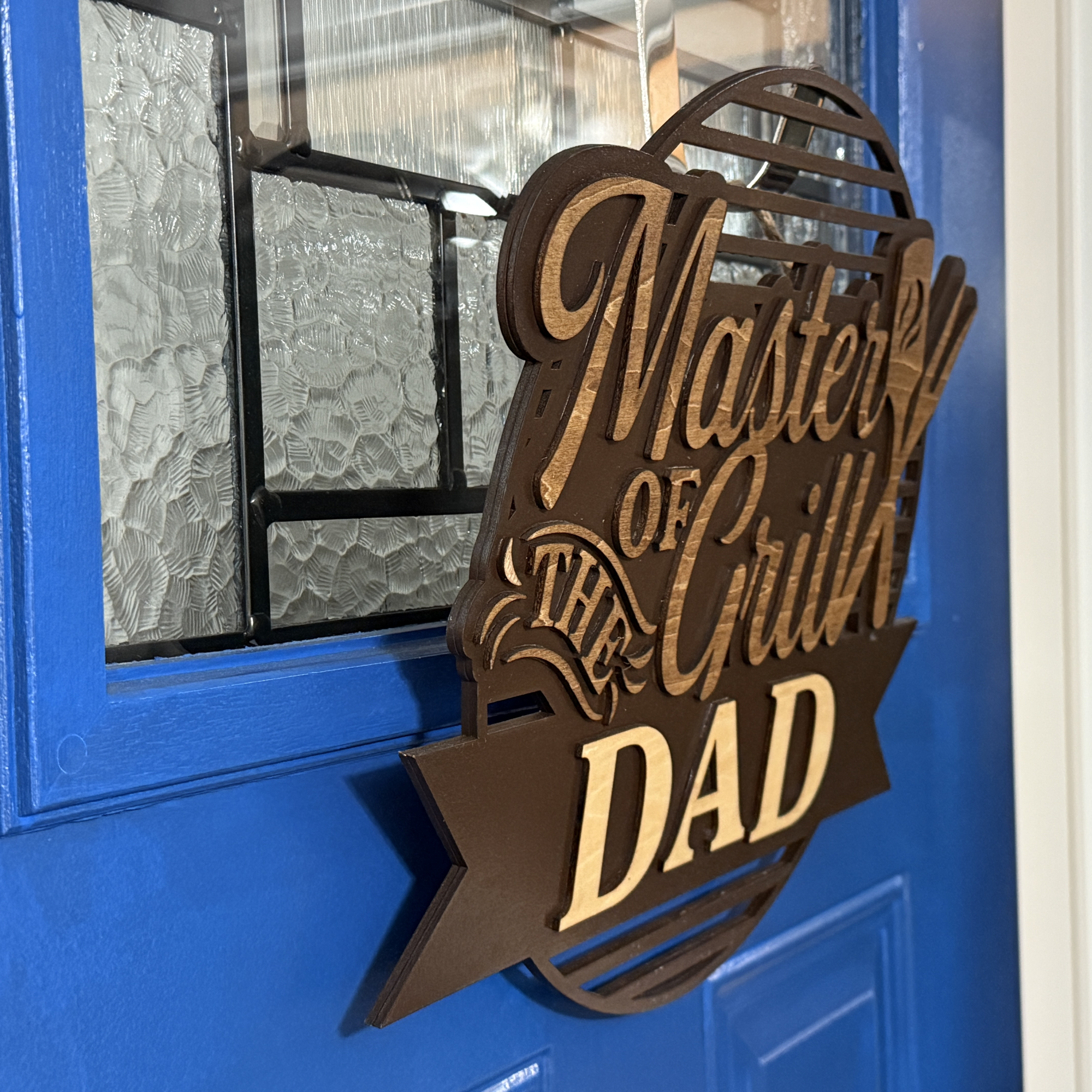 Master of the Grill door hanger, side view, showing base thickness and layered wood details