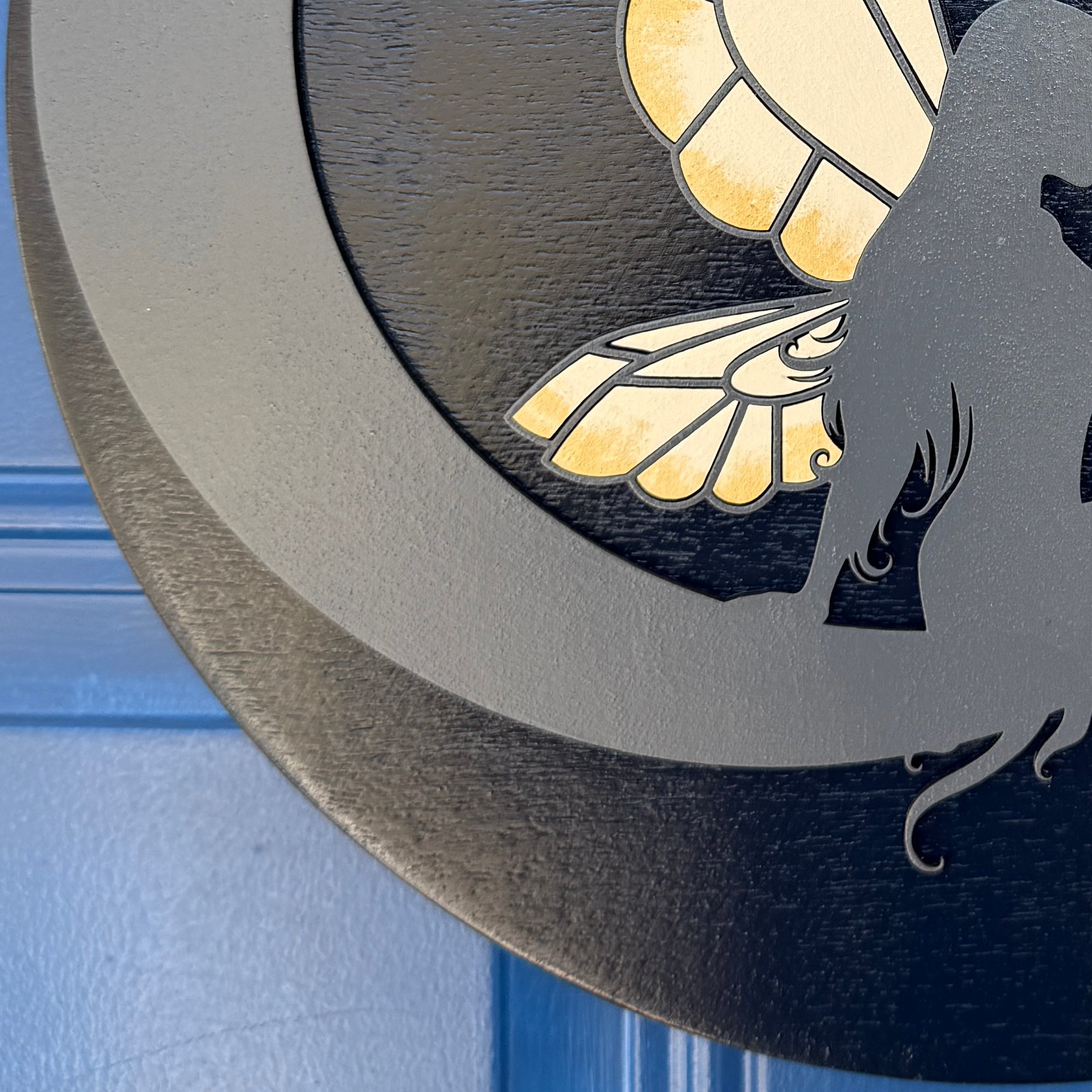Close-up of curved crescent moon edge and layered wood thickness on fairy door hanger
