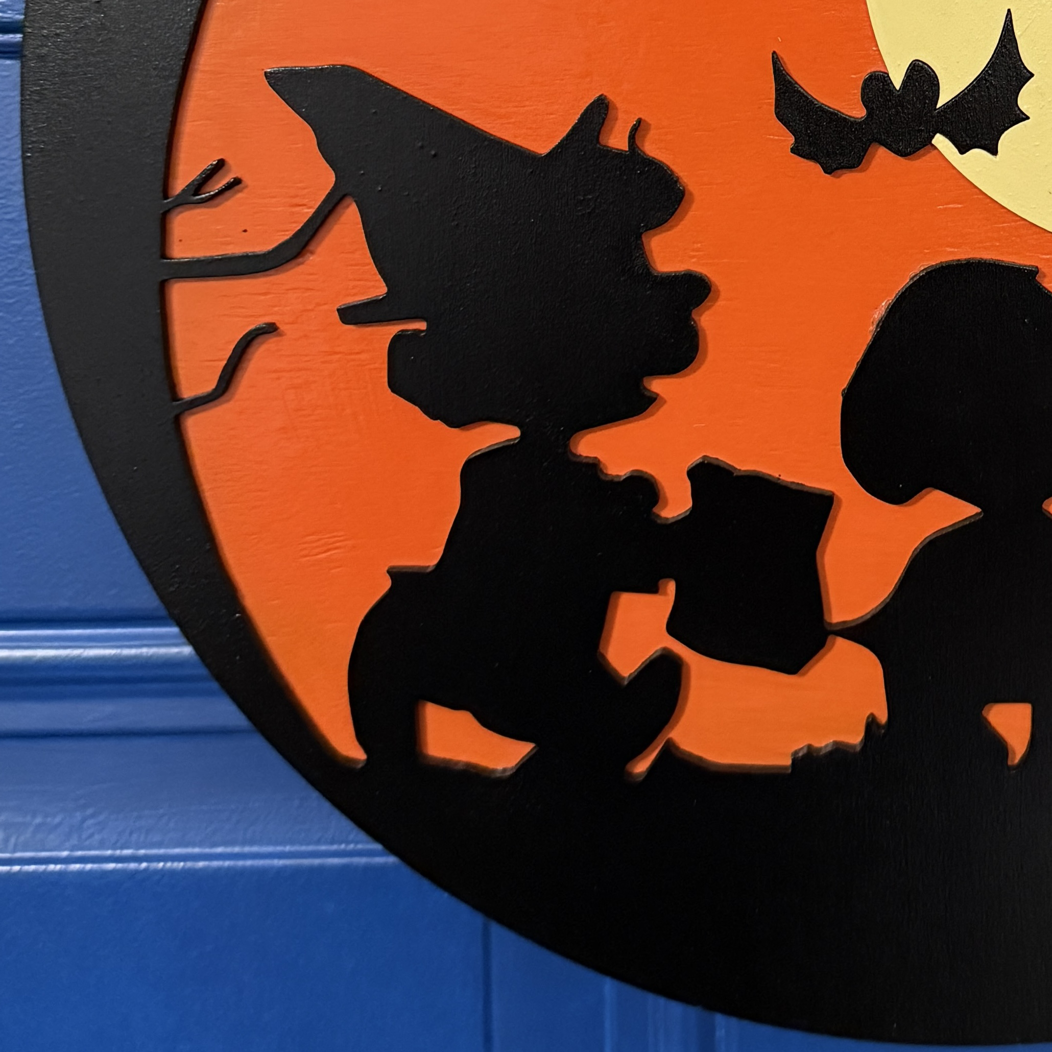Close-up of Trick-or-Treat door hanger highlighting moon, bats, and Peanuts silhouettes