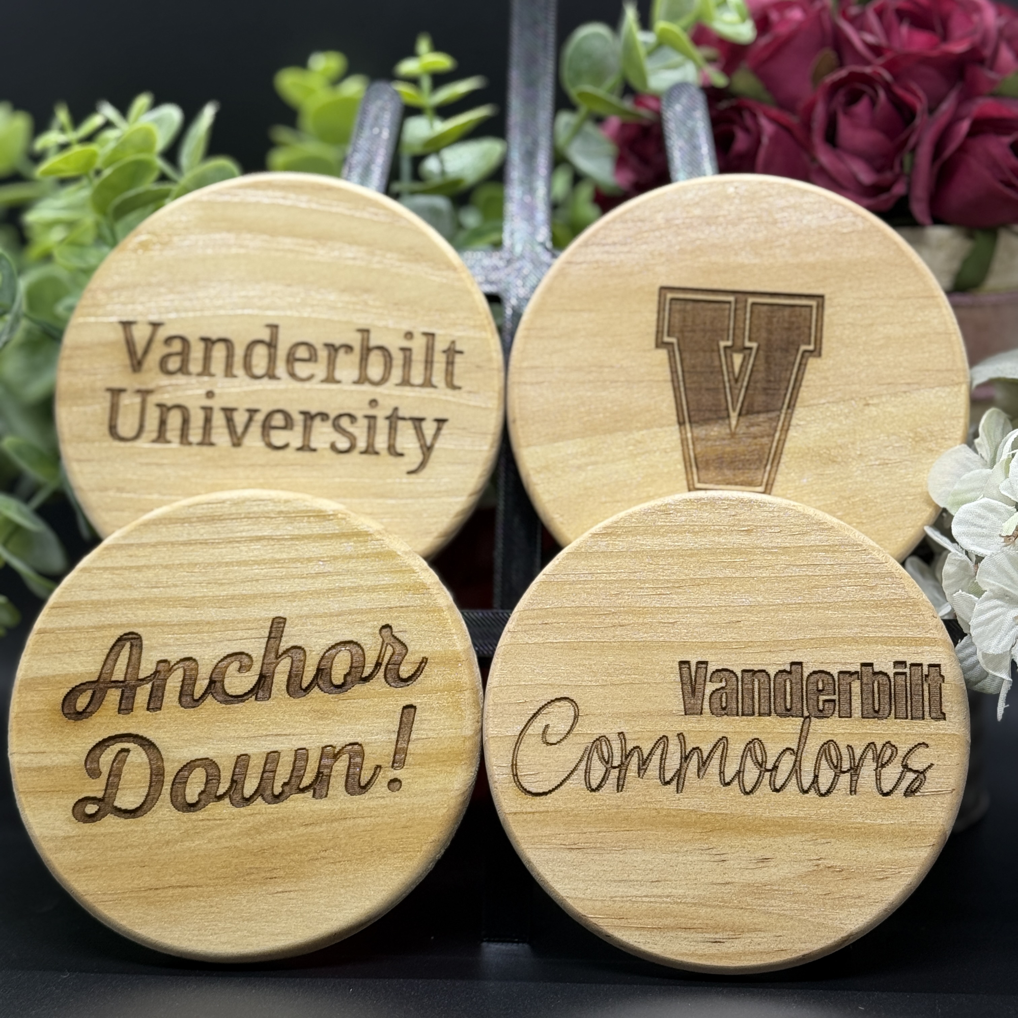 Set of four round Vanderbilt Commodores engraved wooden coasters with designs including Vanderbilt University, block V logo, Anchor Down, and Vanderbilt Commodores