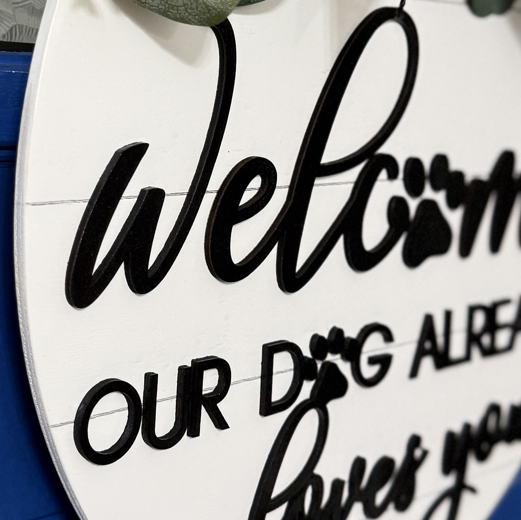 Close-up of lower text “our dog already loves you” in mixed script and print fonts