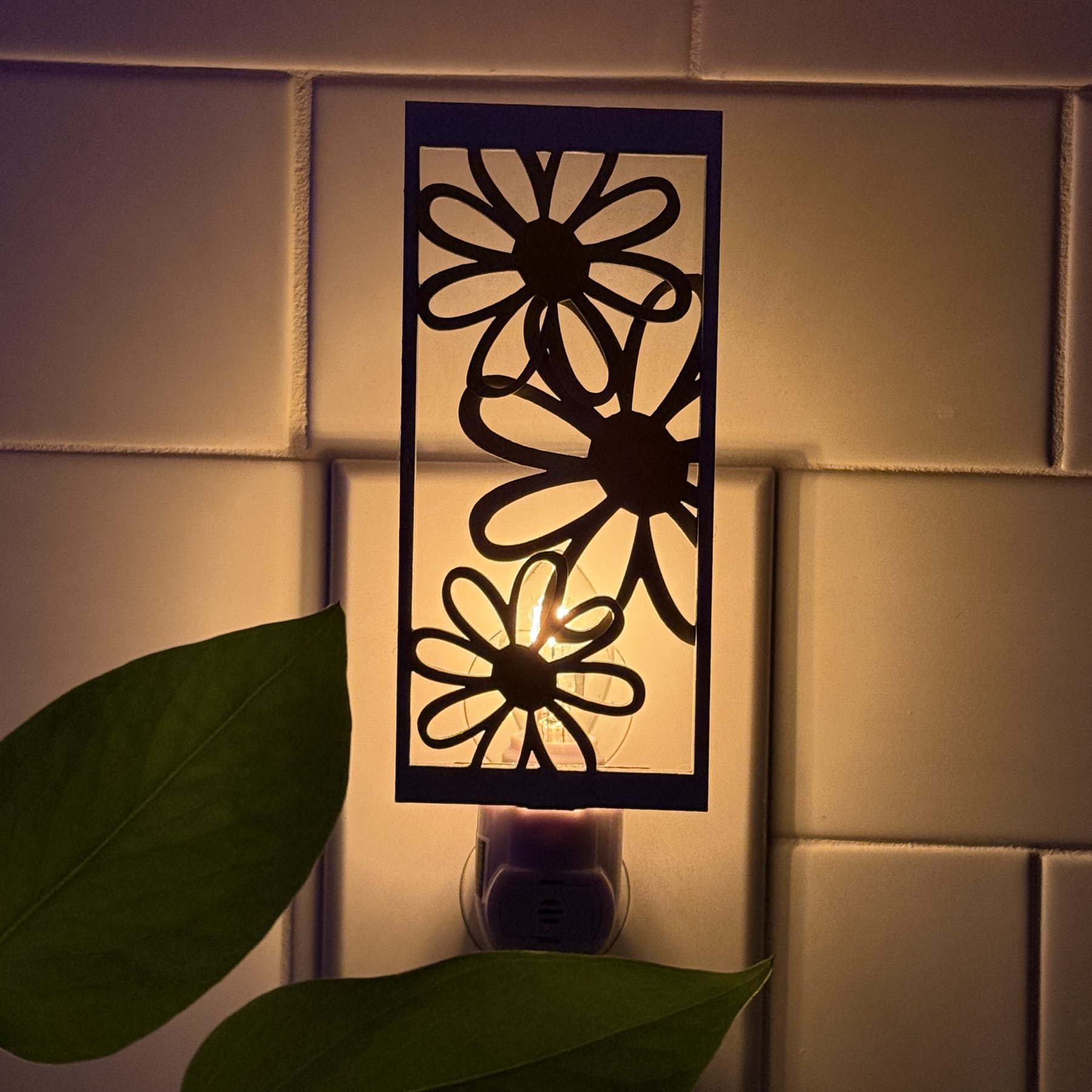 Handcrafted daisy night light with layered wooden flowers in yellow and white, unlit against white tile