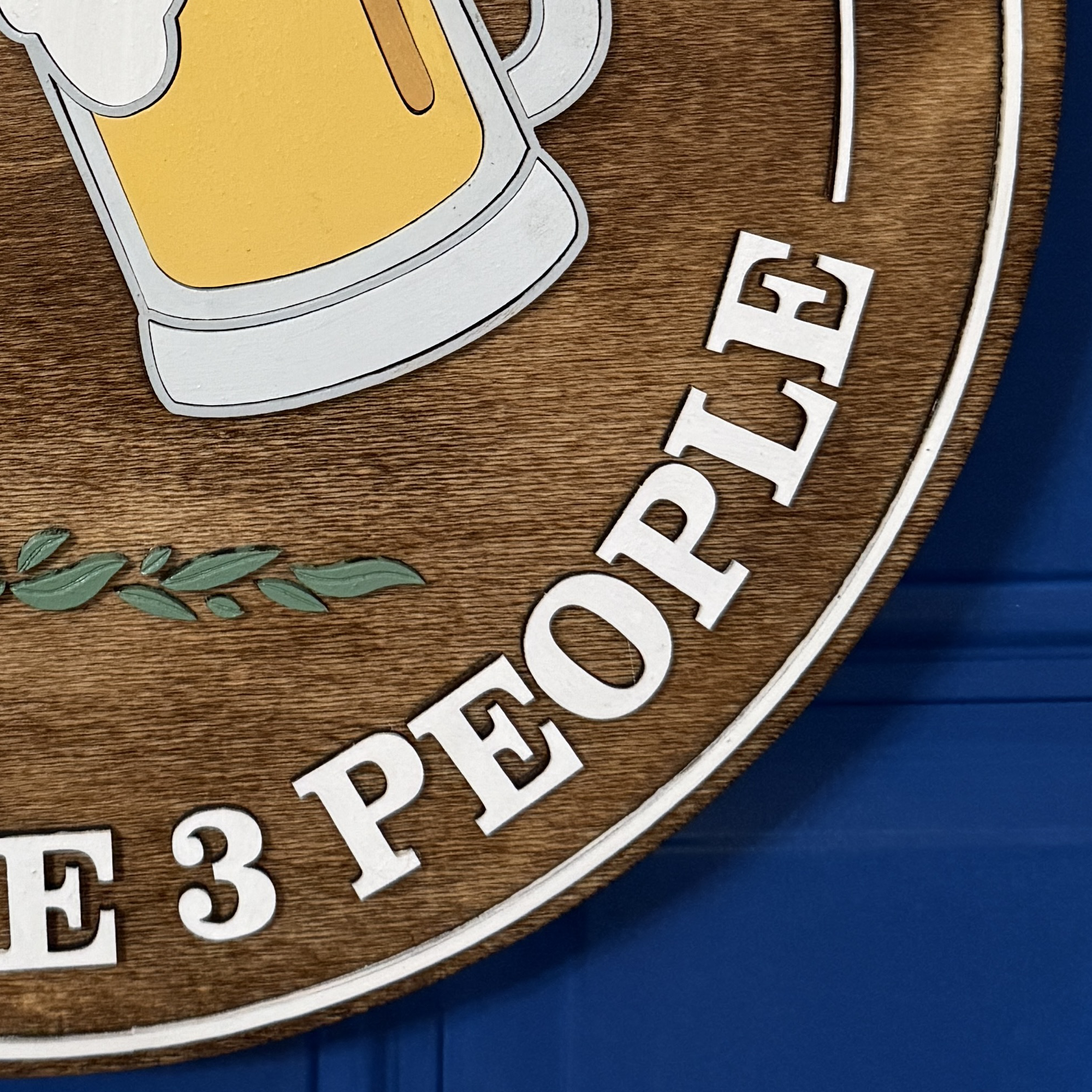 Detail view of dimensional lettering and smooth stained wood grain