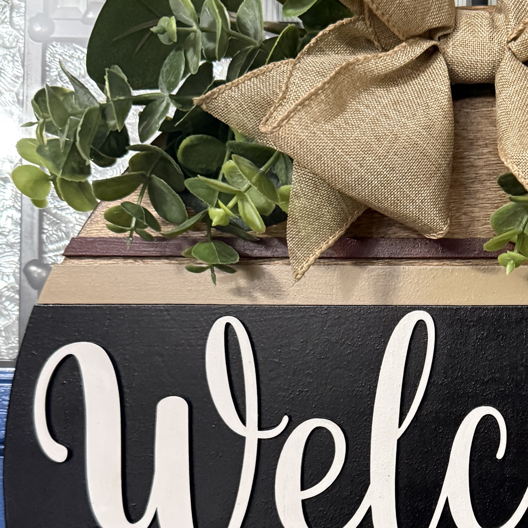 Close-up of “Hope you brought coffee” text on cream banner across sign
