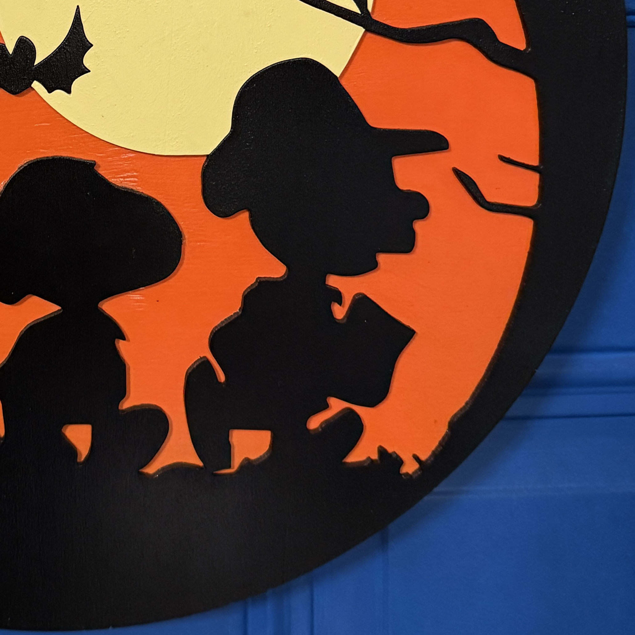 Close-up of Trick-or-Treat door hanger highlighting moon, bats, and Peanuts silhouettes