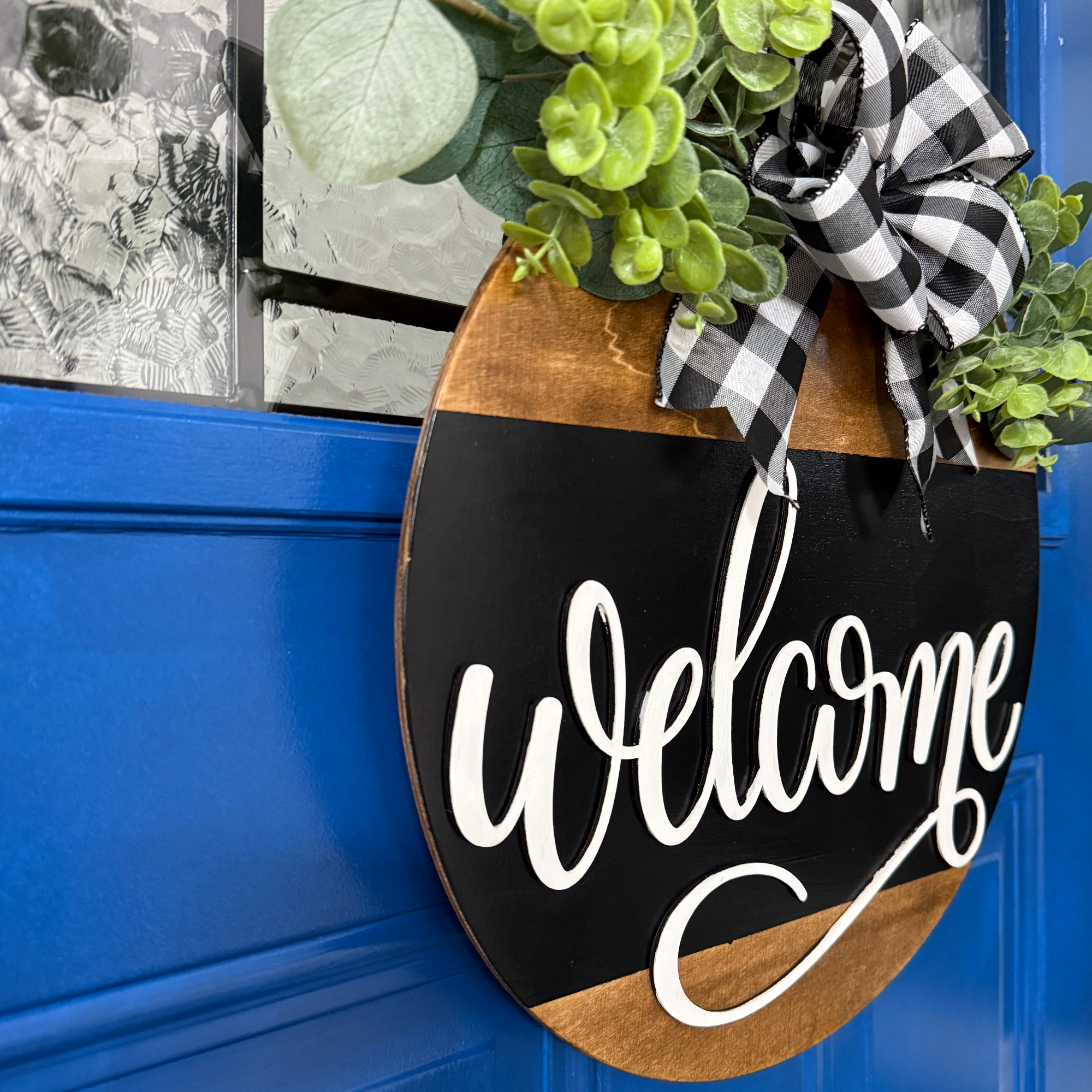 Welcome door hanger, side view, showing base thickness and layered wood details