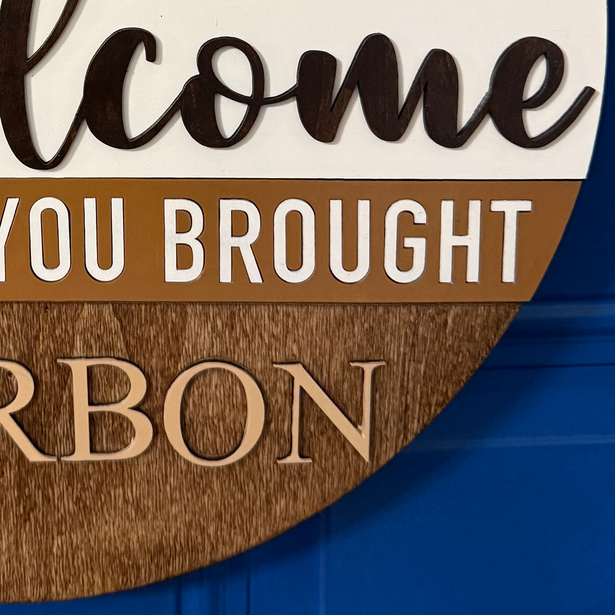Close-up of “Hope you brought bourbon” text across middle of sign