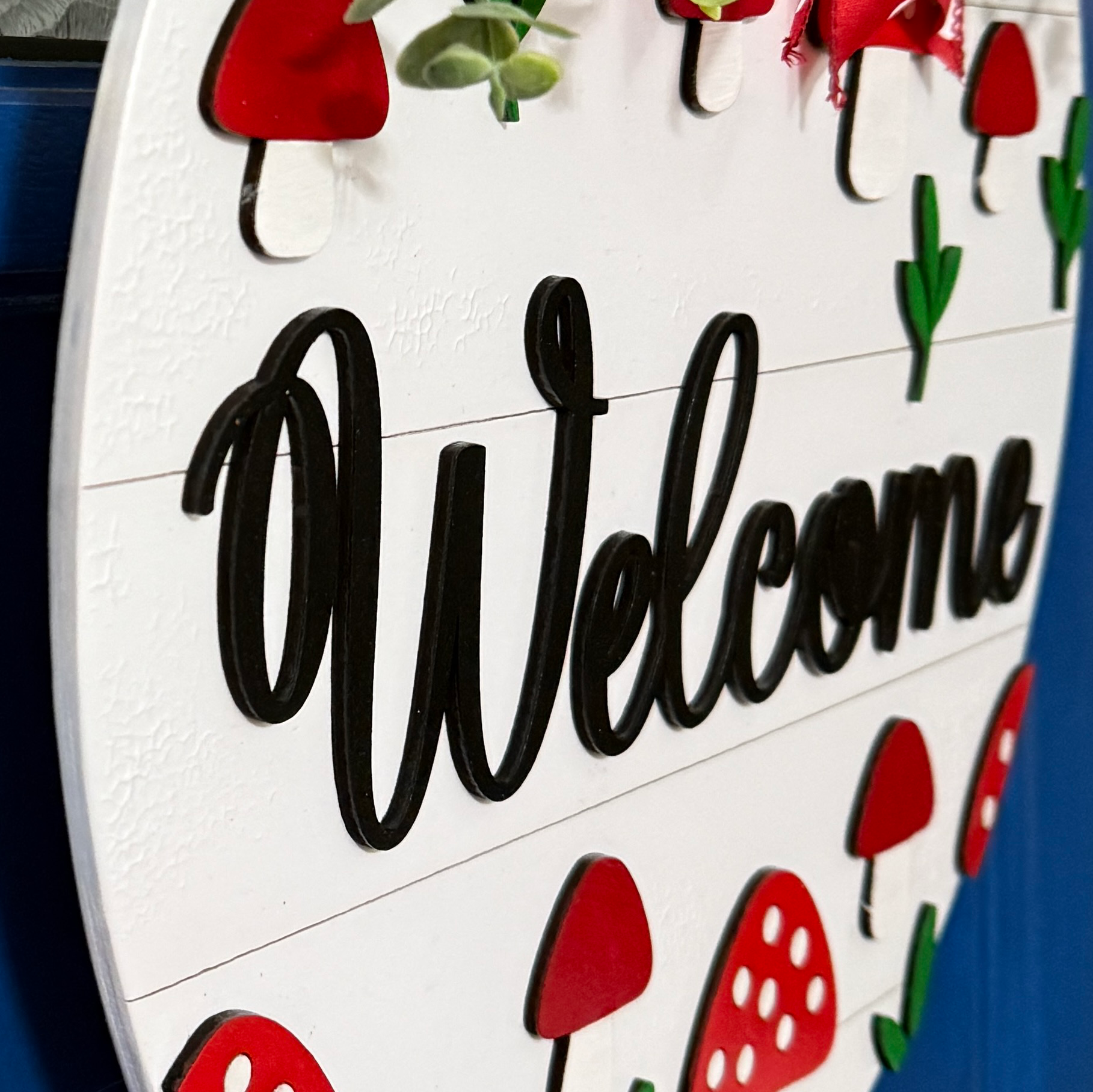 Side view of dimensional mushroom welcome door hanger with red and white accents