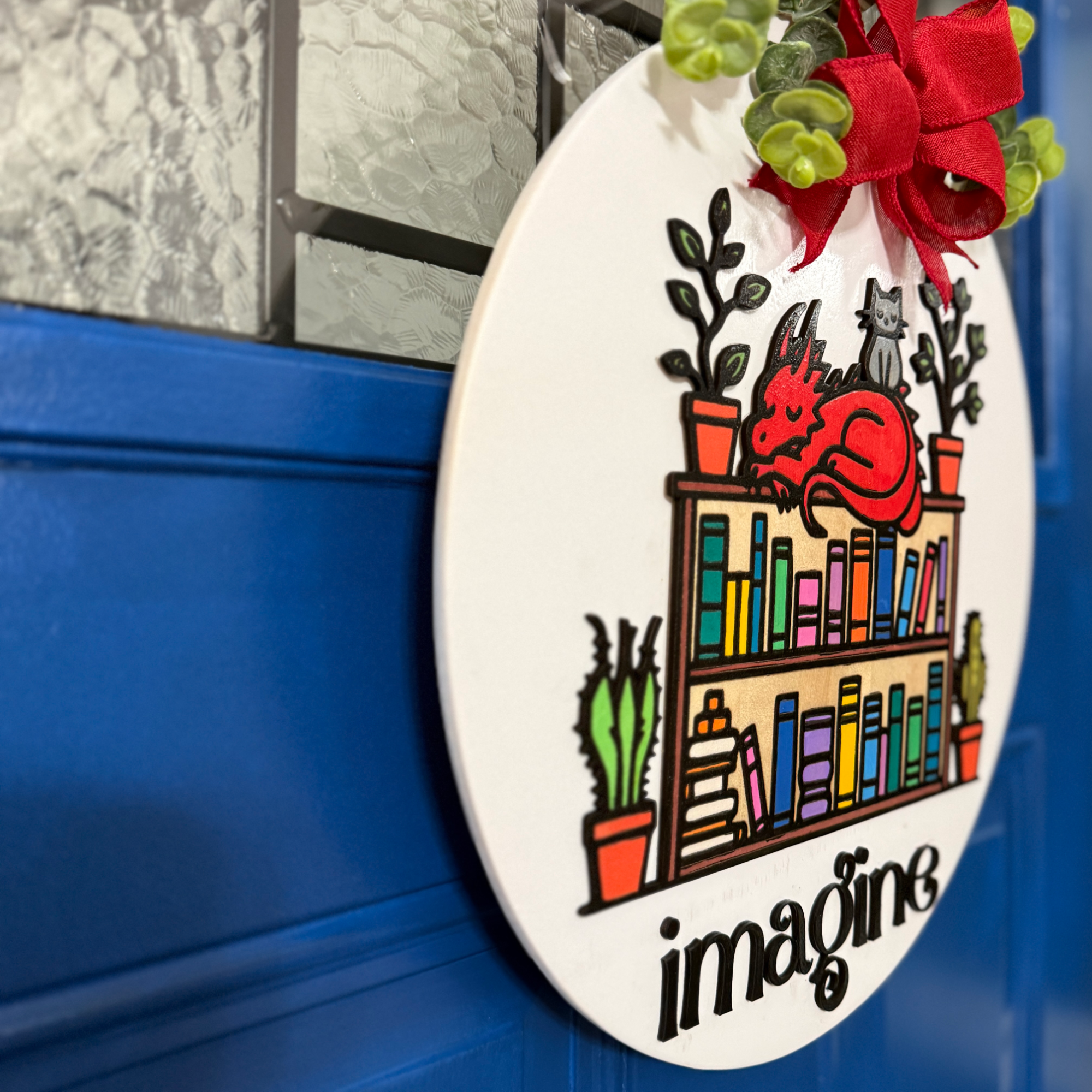 Angled side view of dragon bookshelf door hanger showing layered wood depth against a blue door