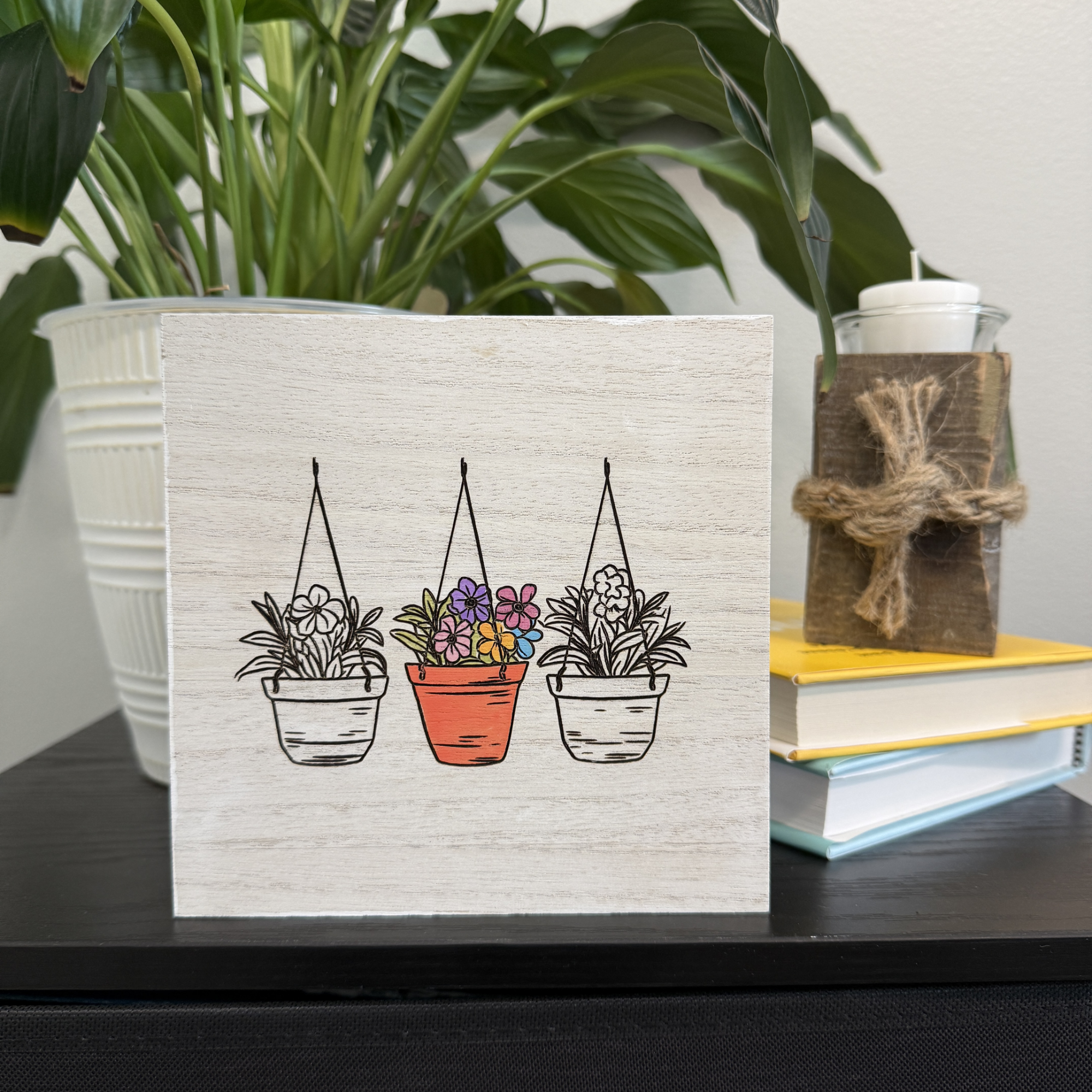 Handcrafted wooden shelf sitter with hanging plant illustration styled on a shelf with houseplant and stacked books