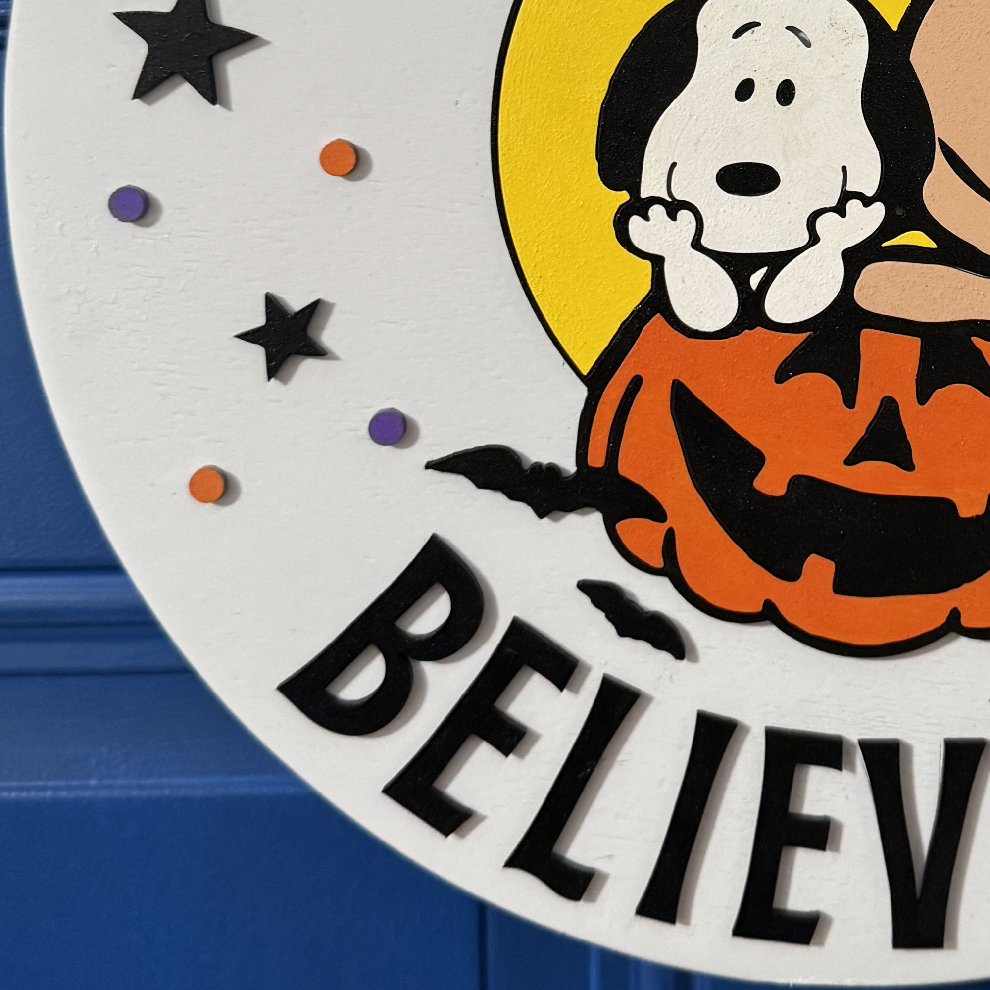 Close-up of Halloween door hanger highlighting hand-painted characters and pumpkin details