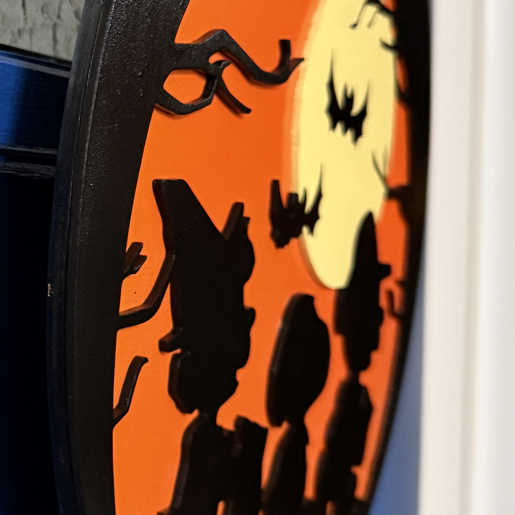Close-up of Trick-or-Treat door hanger highlighting moon, bats, and Peanuts silhouettes