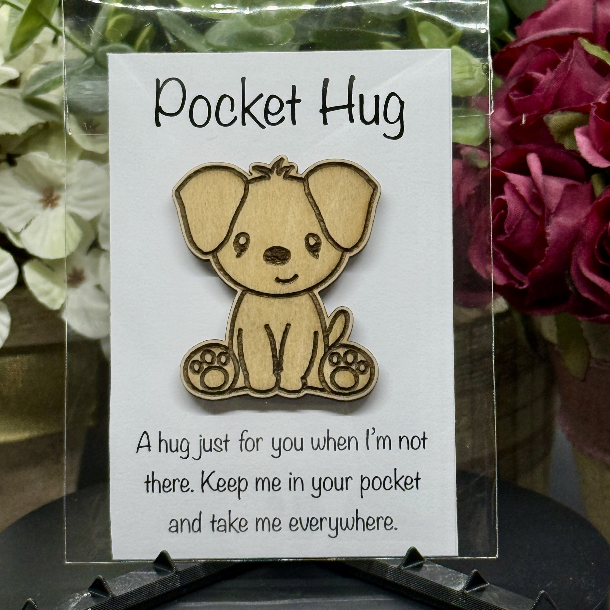 Classic Pup Pocket Hug token on printed card with green floral background – laser-cut wooden dog with floppy ears