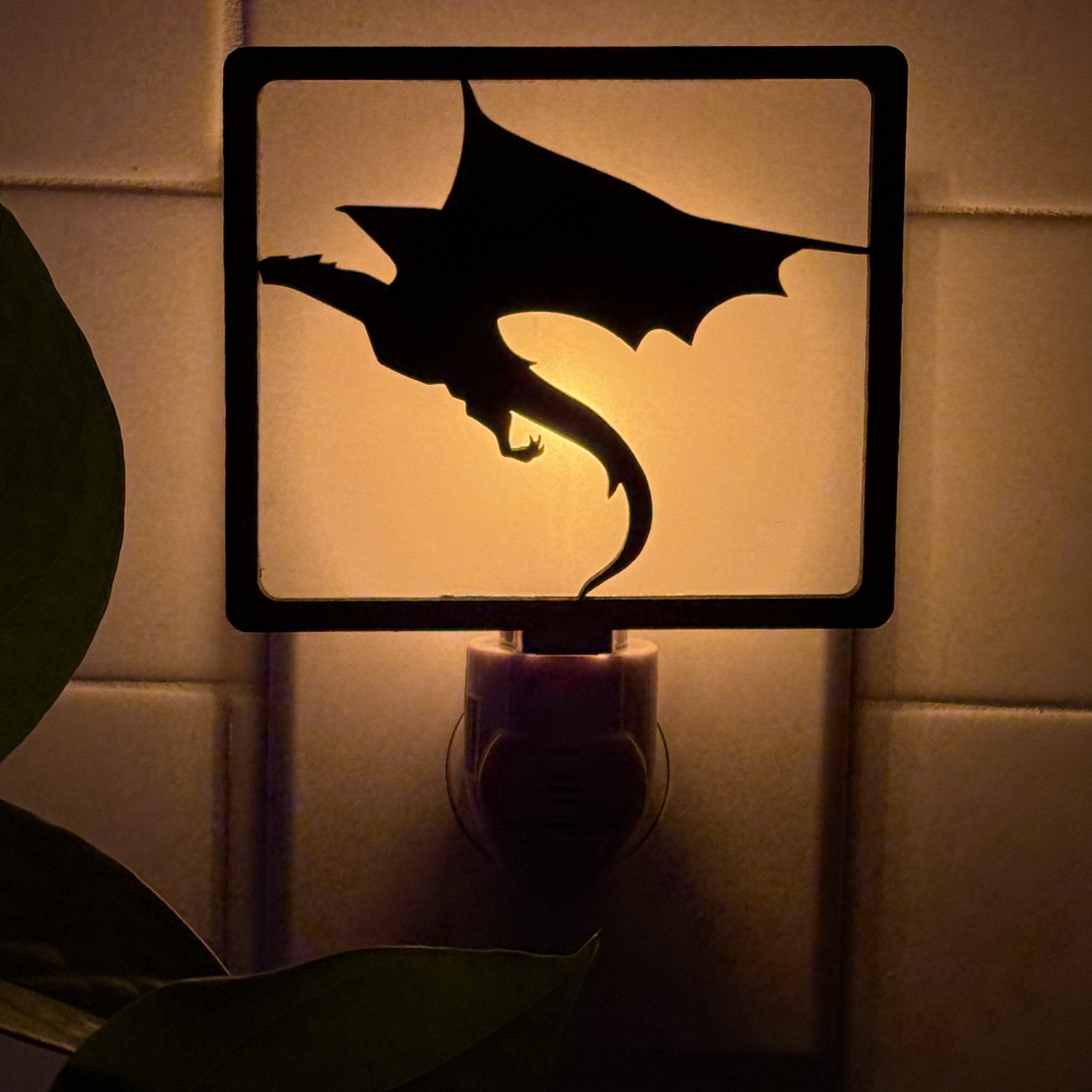Soaring Dragon night light glowing – warm light behind a dragon in mid-flight.