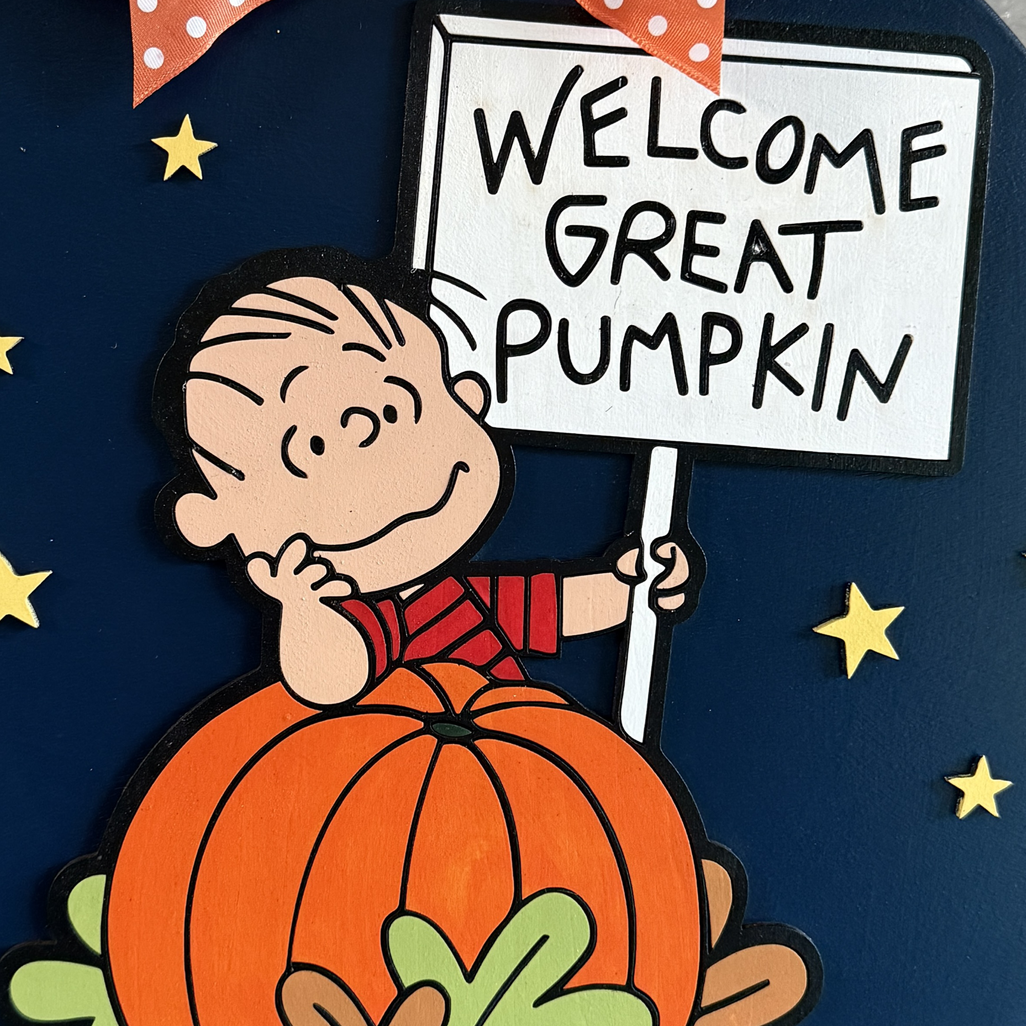 Close-up of Linus and pumpkin details on the Peanuts “Welcome Great Pumpkin” fall door hanger
