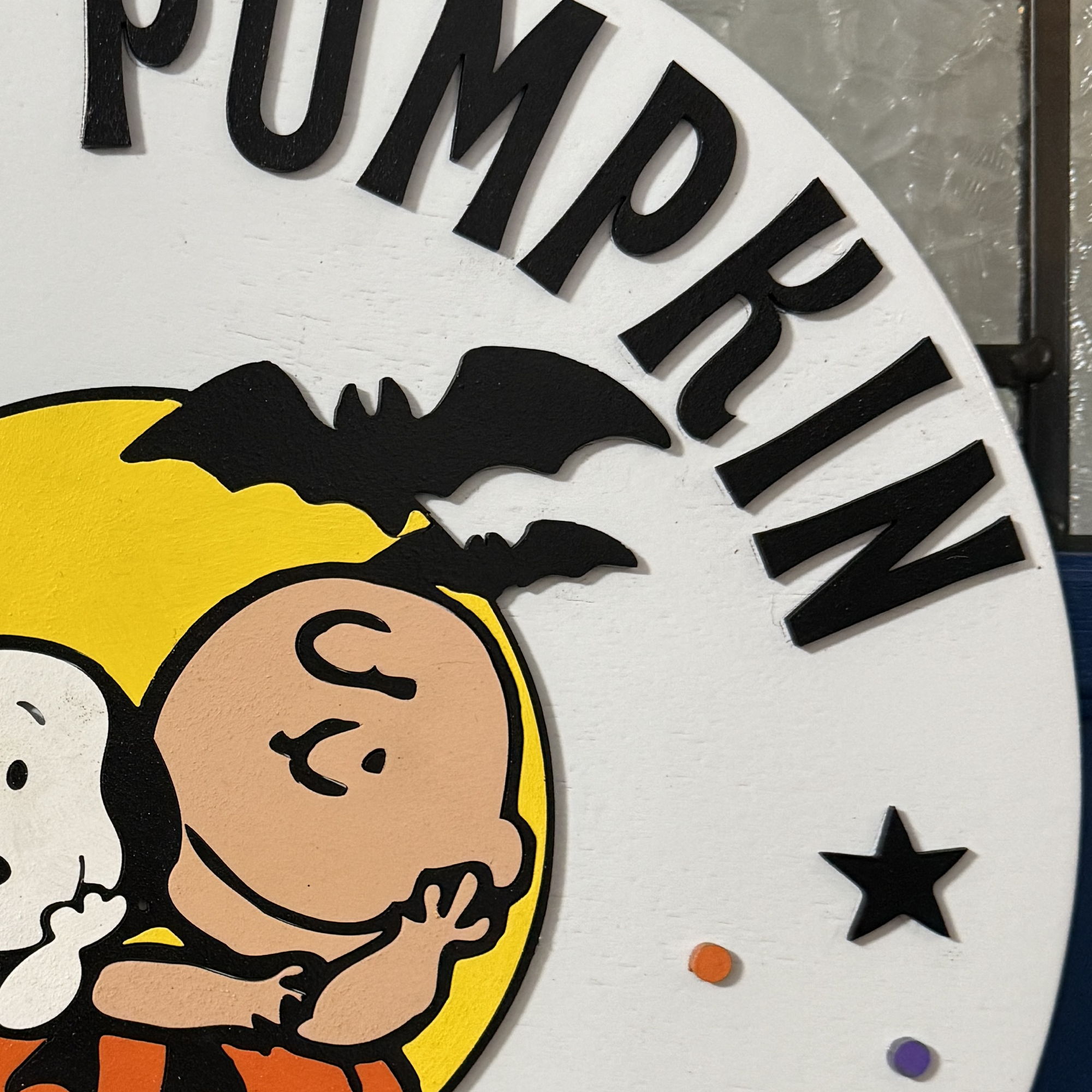 Close-up of Halloween door hanger highlighting hand-painted characters and pumpkin details