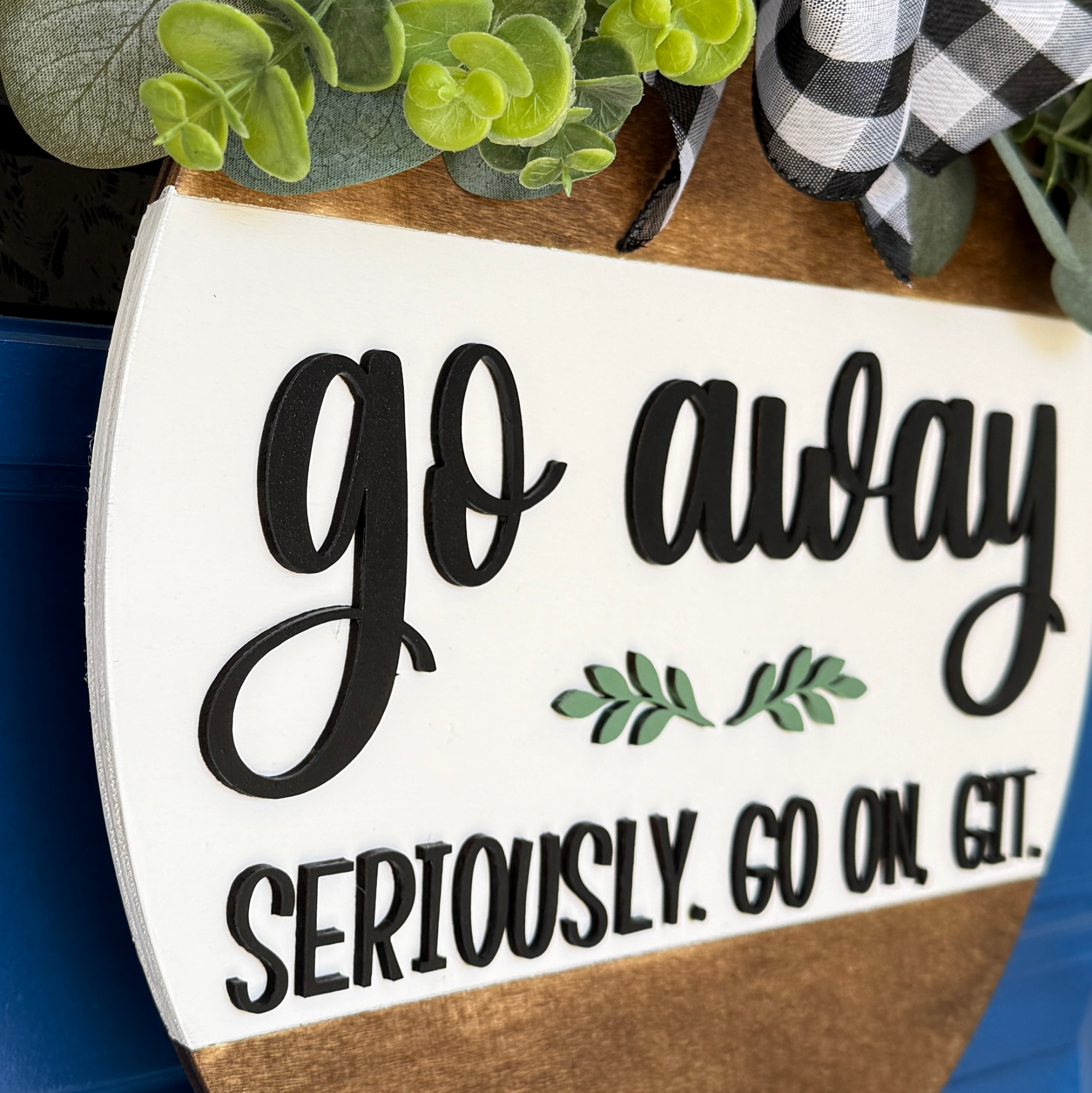 Side view of "Go Away" wooden sign